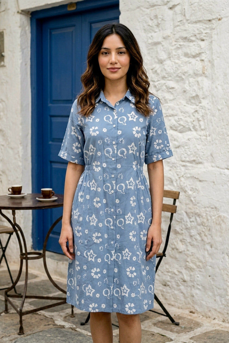 Front full look of blue handblock cotton collar-neck dress with white floral Q print on model.