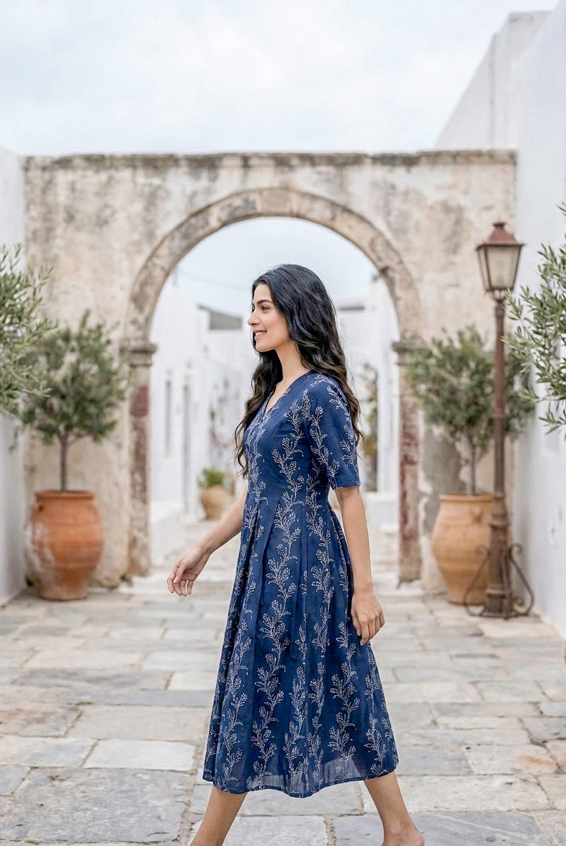 Side profile of woman wearing indigo botanical handblock cotton fit-and-flare dress.