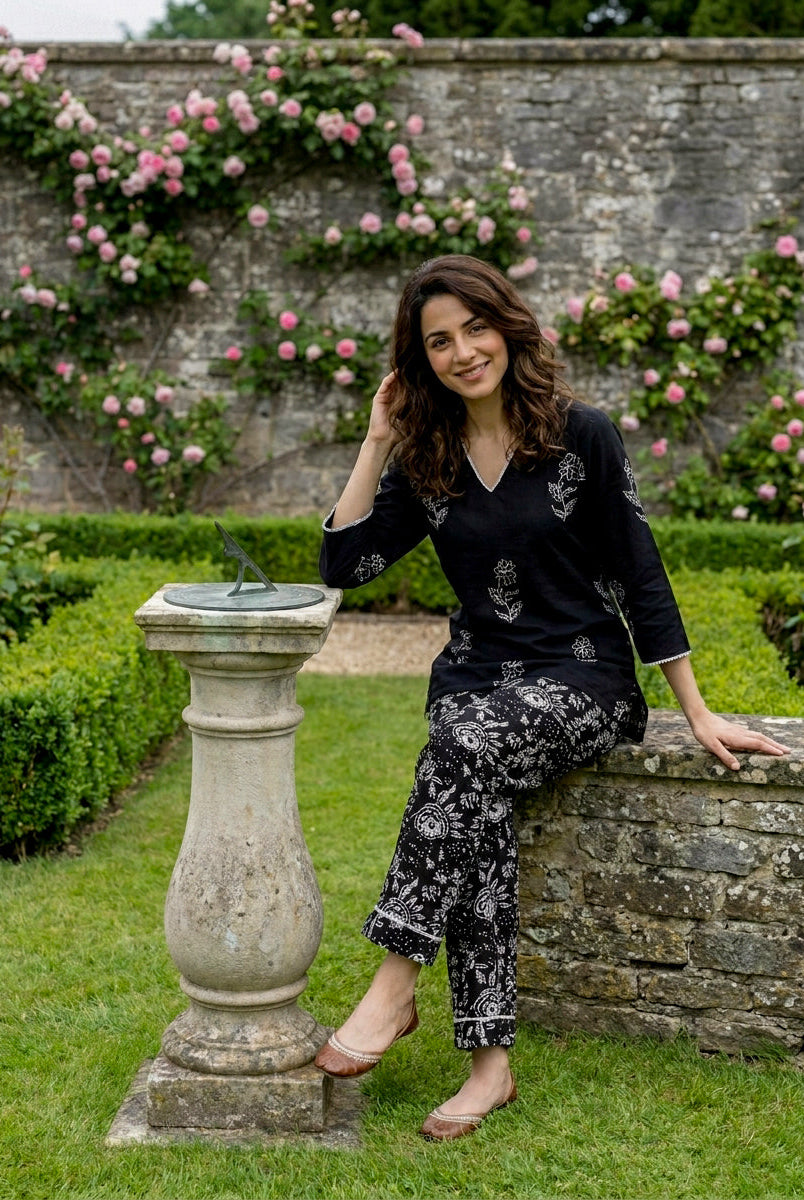 Smiling model in black and ivory hand-block printed kurta and matching pants.