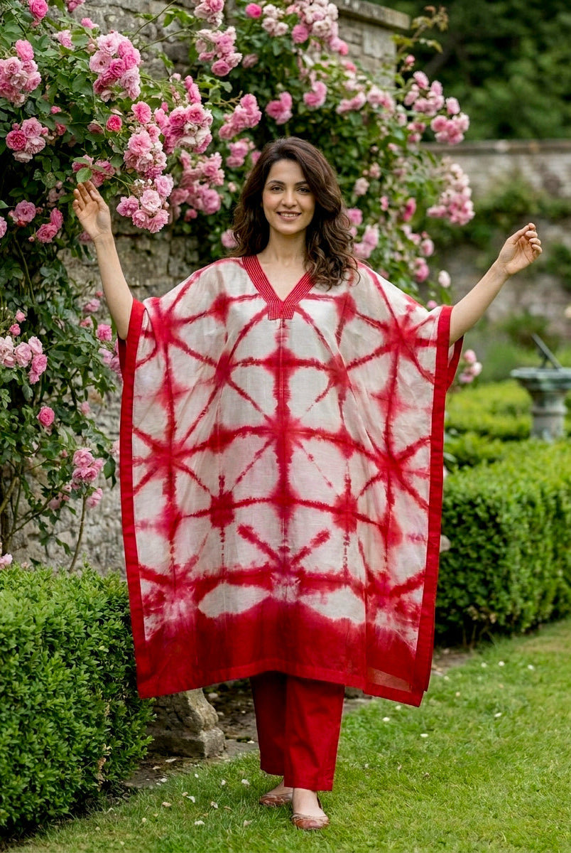Front full look: model in coral red tie-dye silk kaftan and cotton pants.