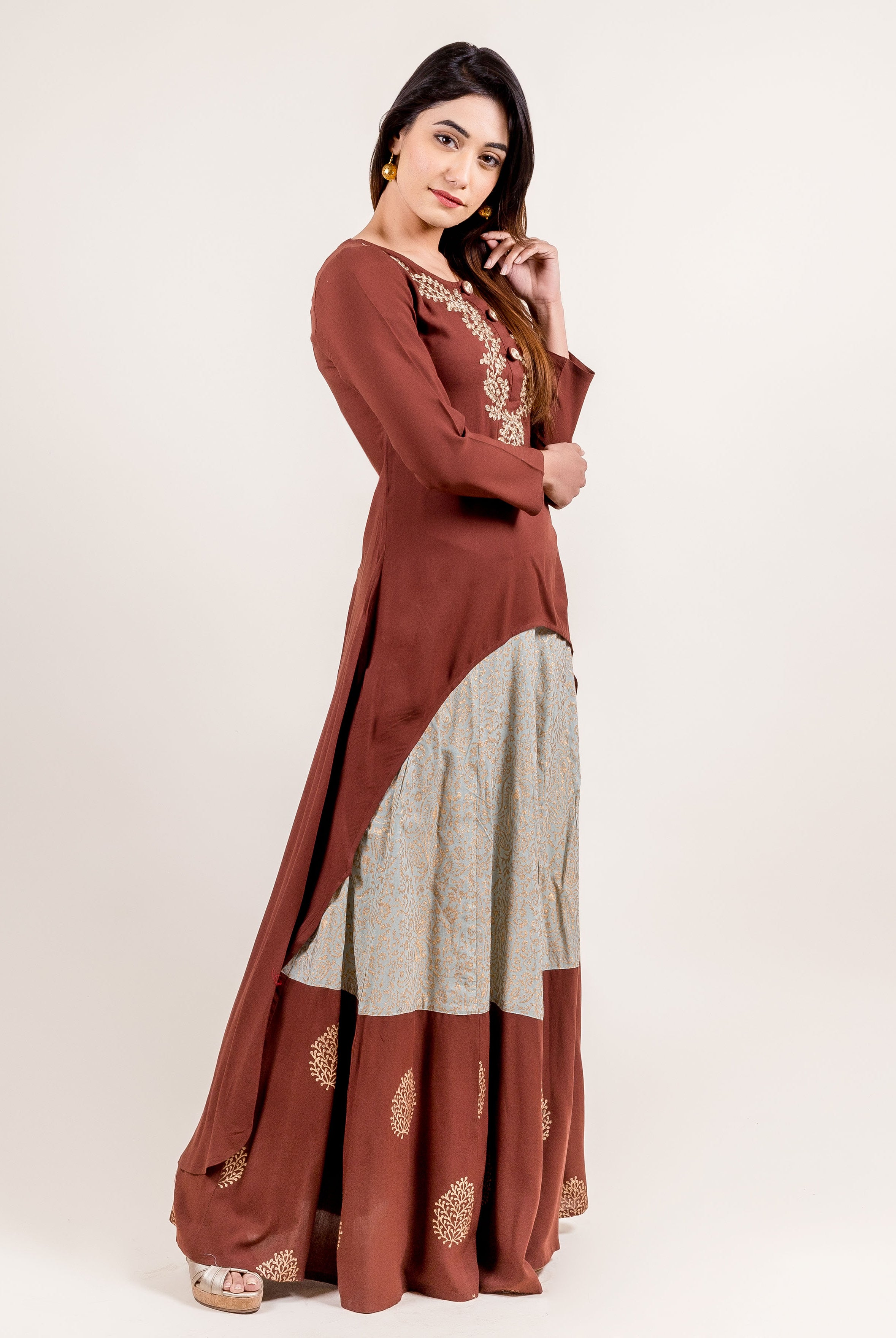 Model wearing asymmetrical brown embroidered kurta and hand-block-printed skirt.