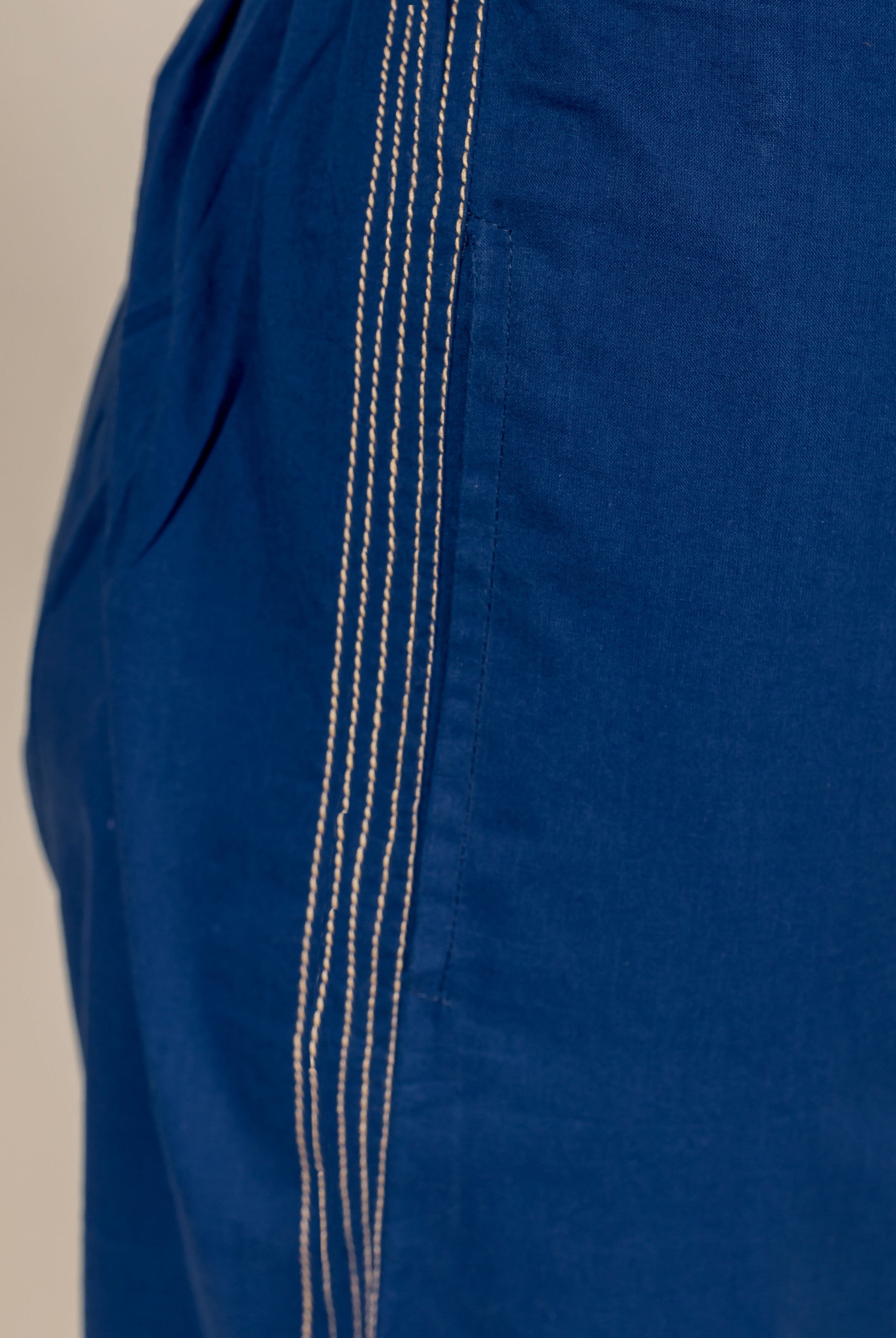 Dark blue cotton palazzo pants with white stitching detail down the side.