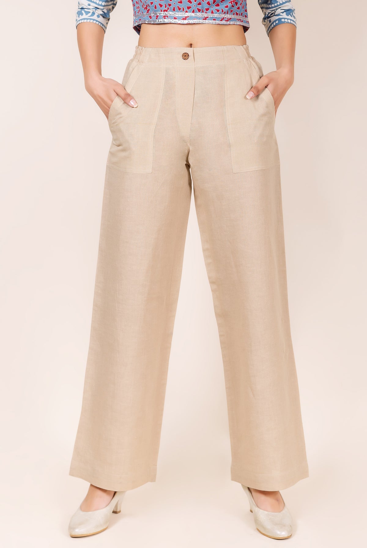 Front view of beige linen solid wide-leg pants on a model, with patch pockets.