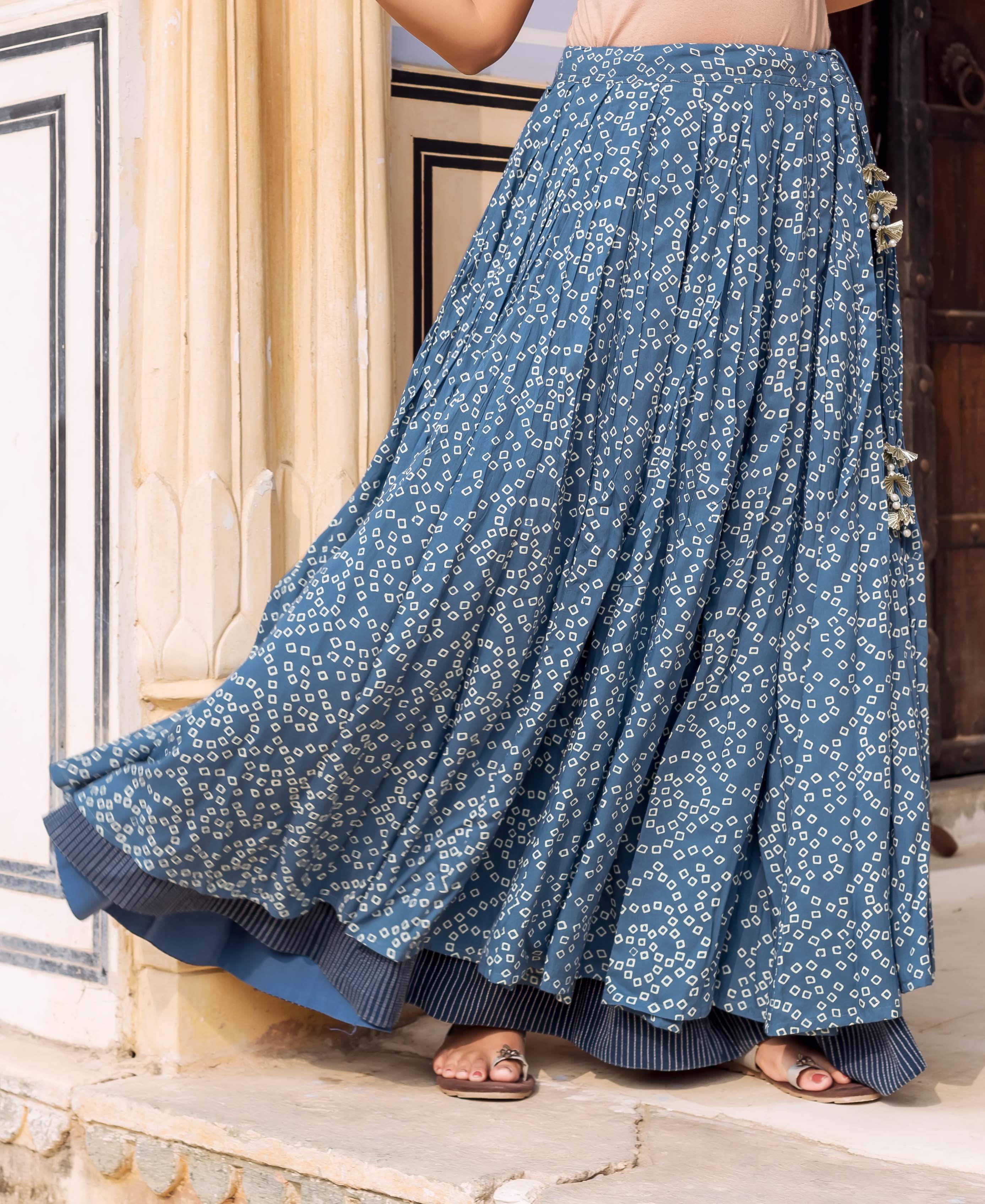 Indigo blue bandhej printed double-layered pleated skirt with tassels on a model.