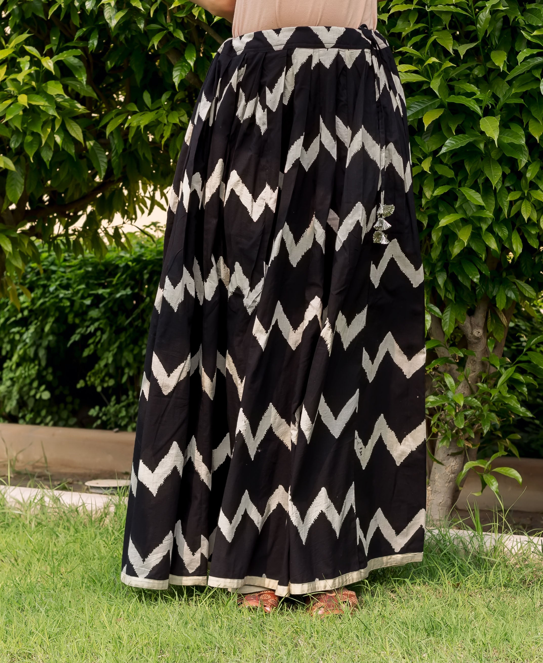 Model in a black full-length skirt with white hand-block zig-zag pattern.