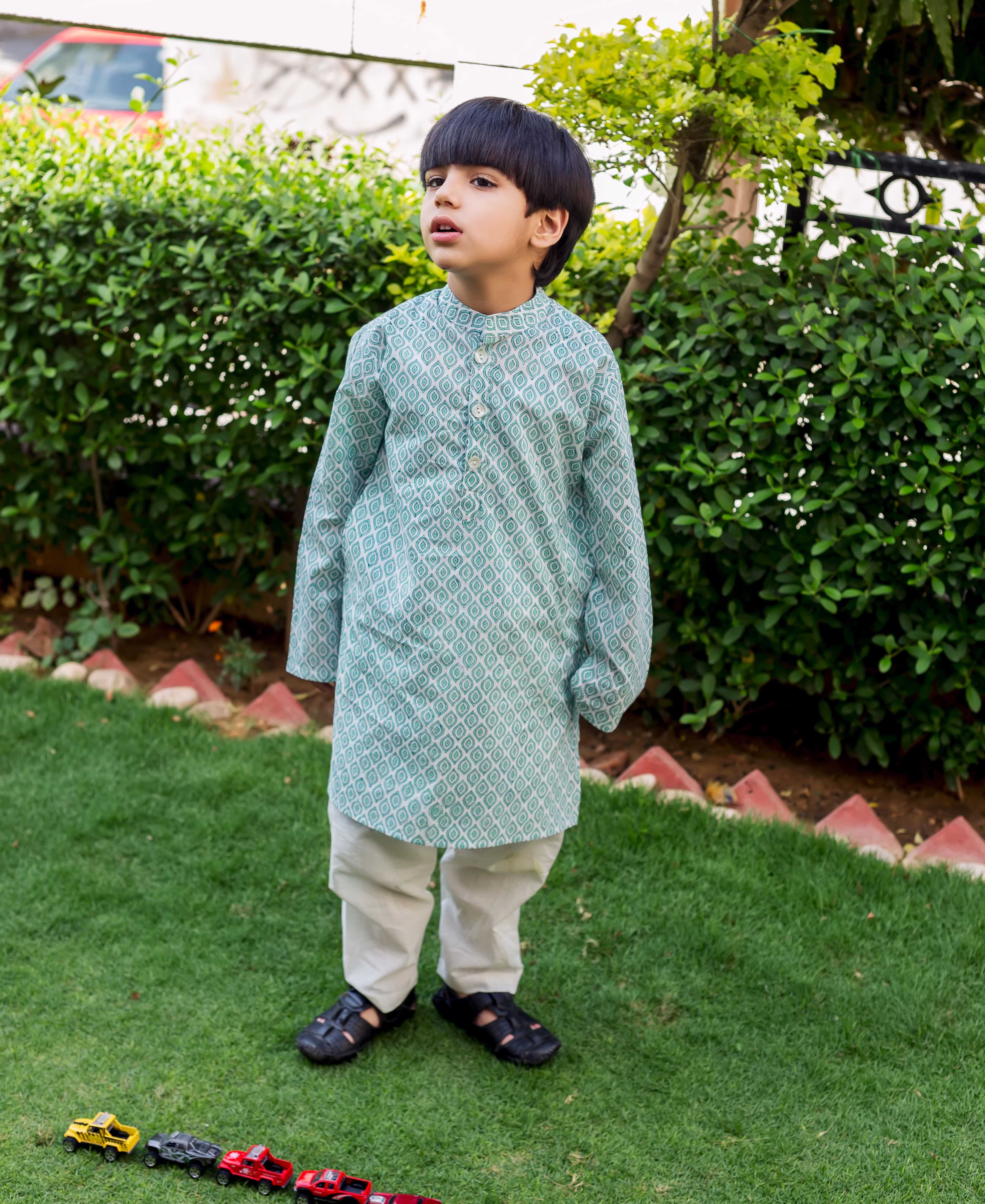 Front full look on model of teal and white block printed cotton kurta pajama set.