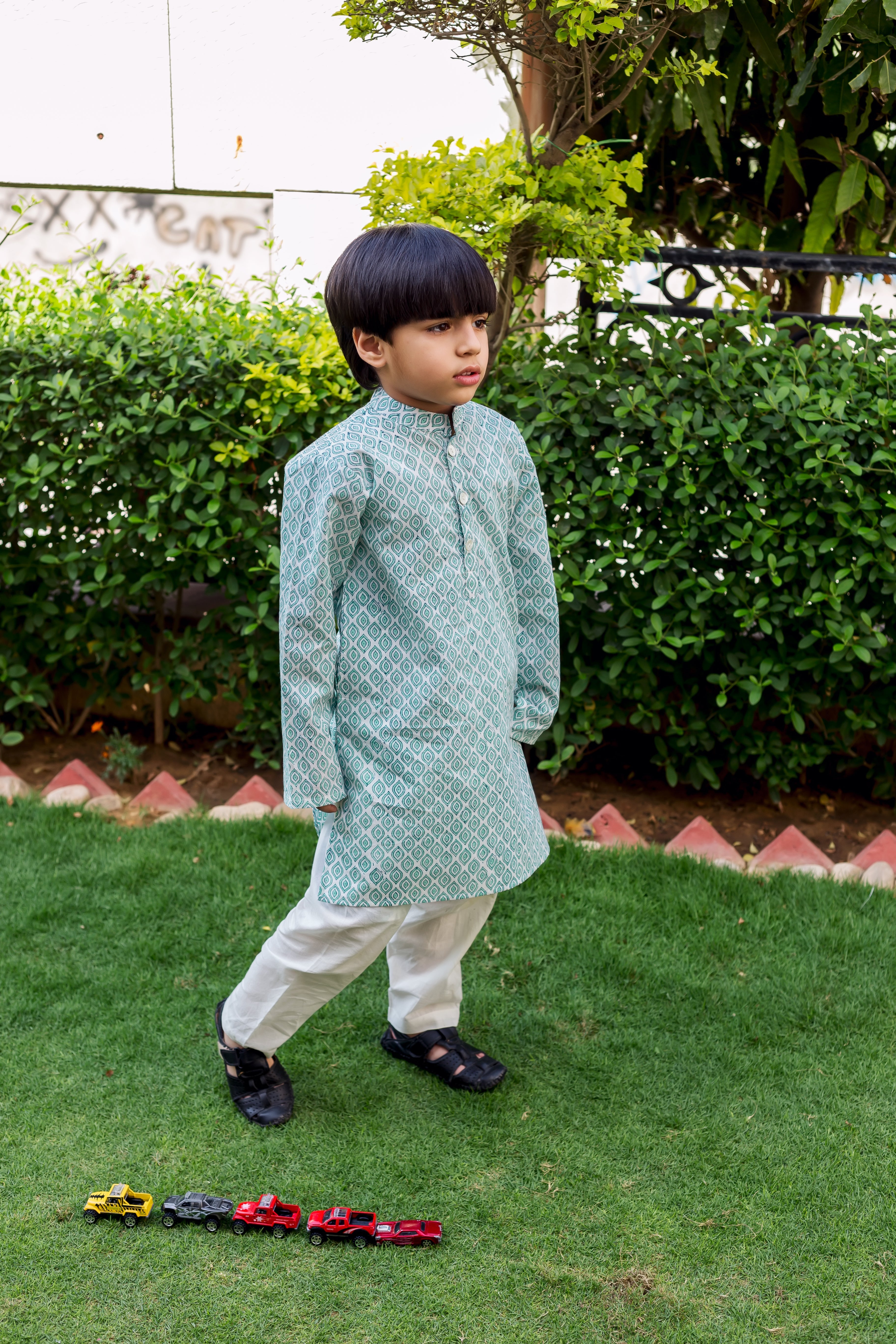 Blue and white block printed cotton kurta pajama set on a boy.