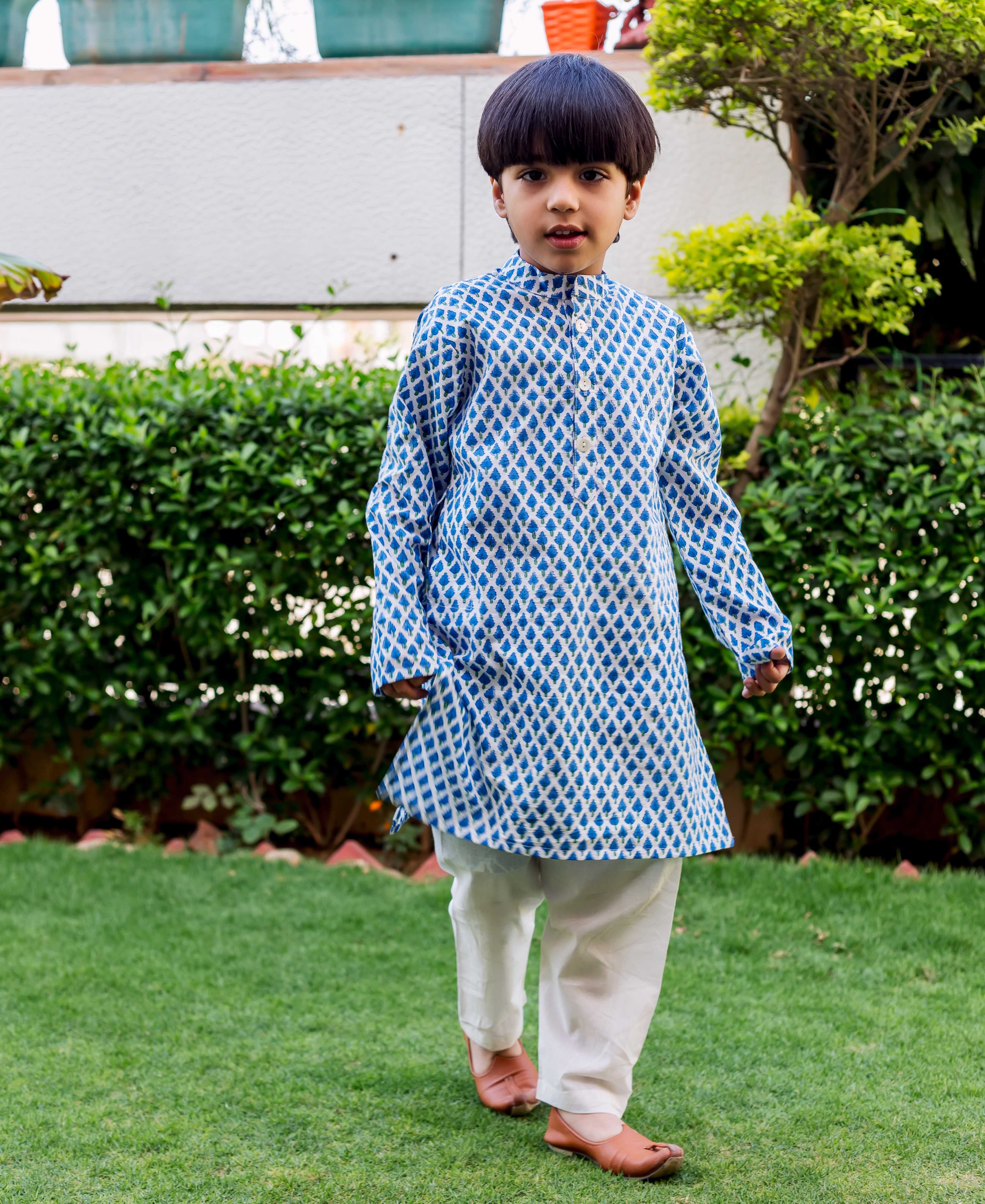 Young boy wearing a blue and white diamond booti printed cotton kurta pajama set.