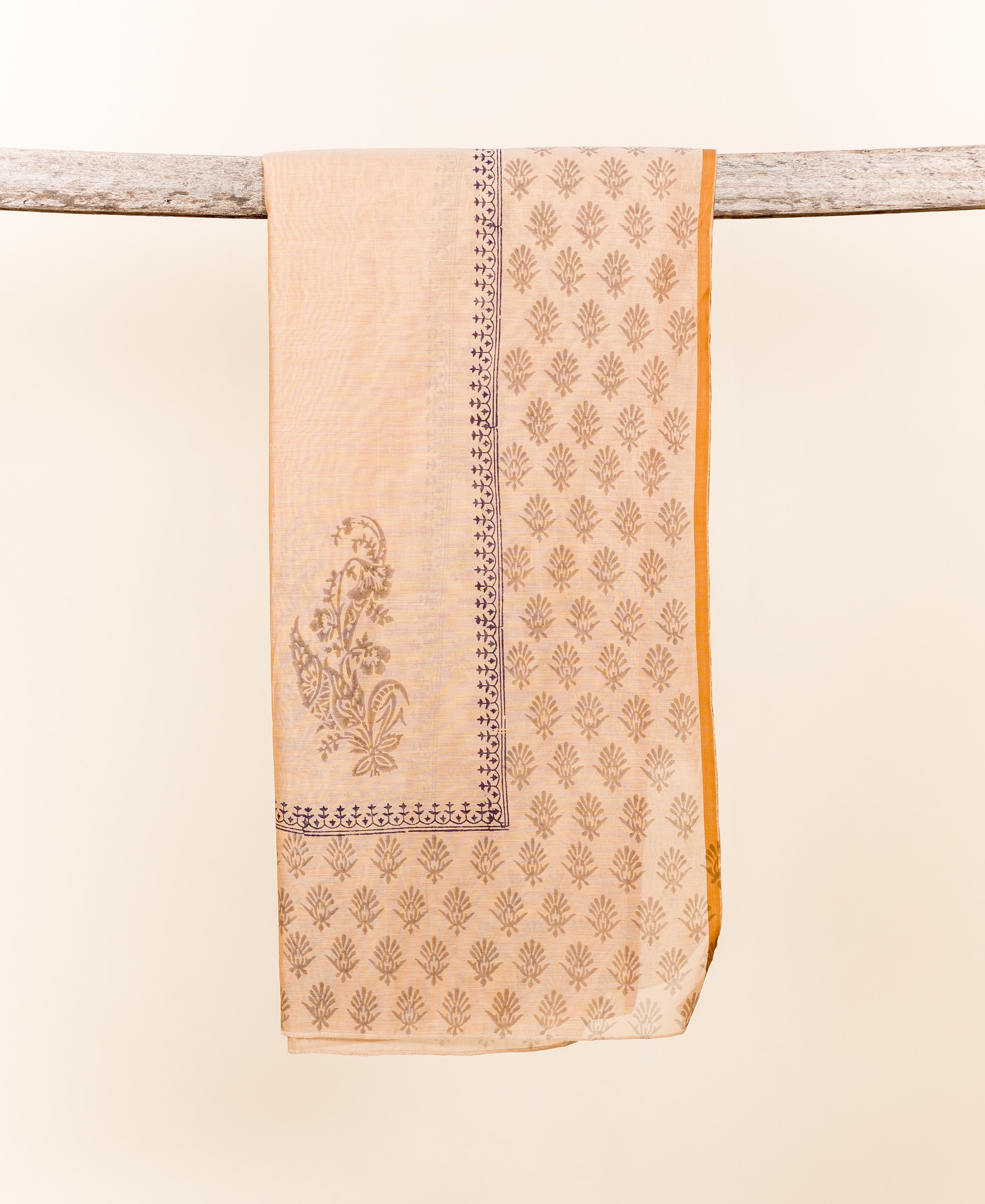 Beige chanderi dupatta with indigo block printed floral and paisley patterns, mustard border, draped.