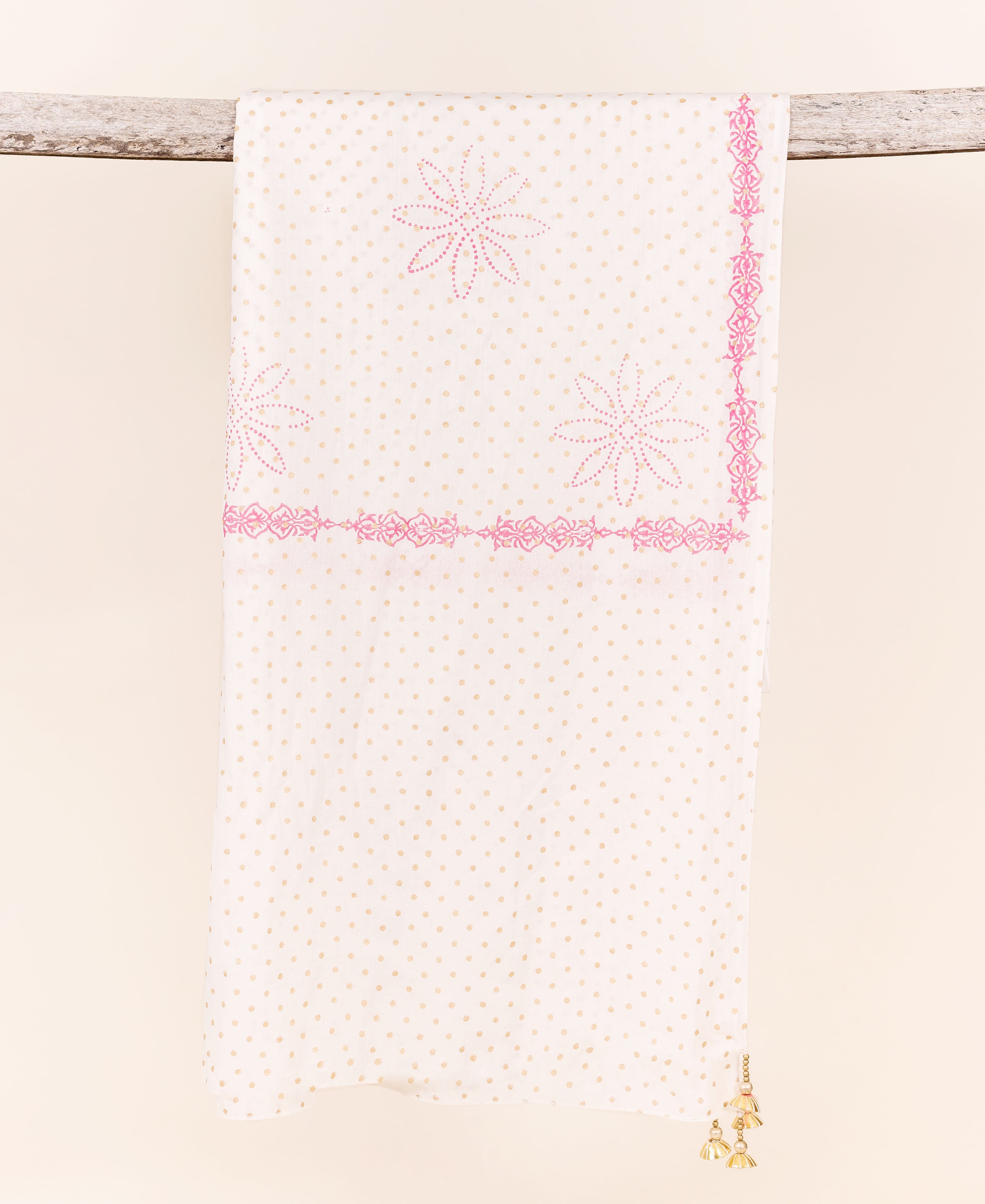 White dupatta with beige polka dots, pink floral prints, border design, and golden tassels.