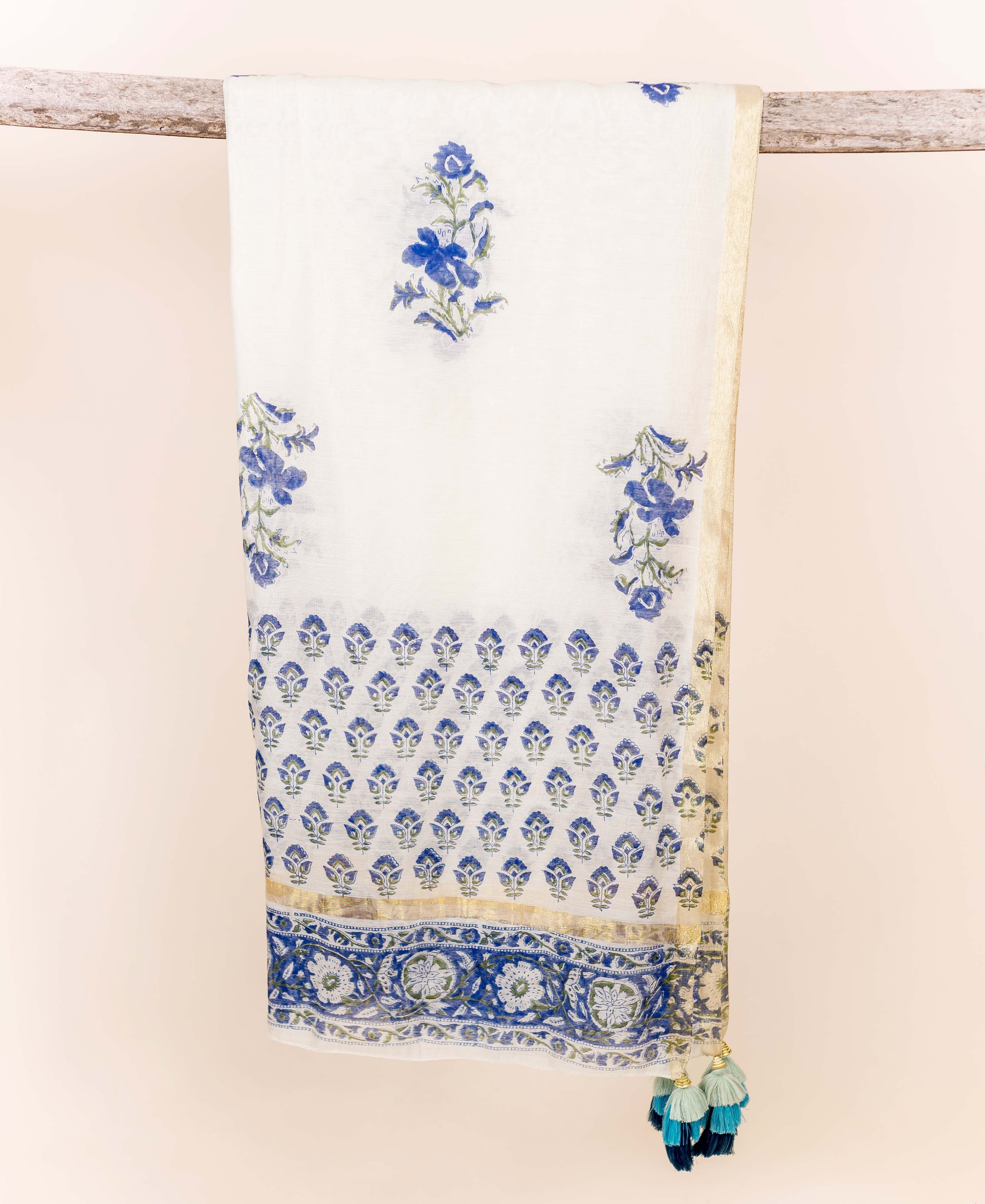 Blue and white block printed chanderi dupatta with floral patterns, gold border, and tassels.