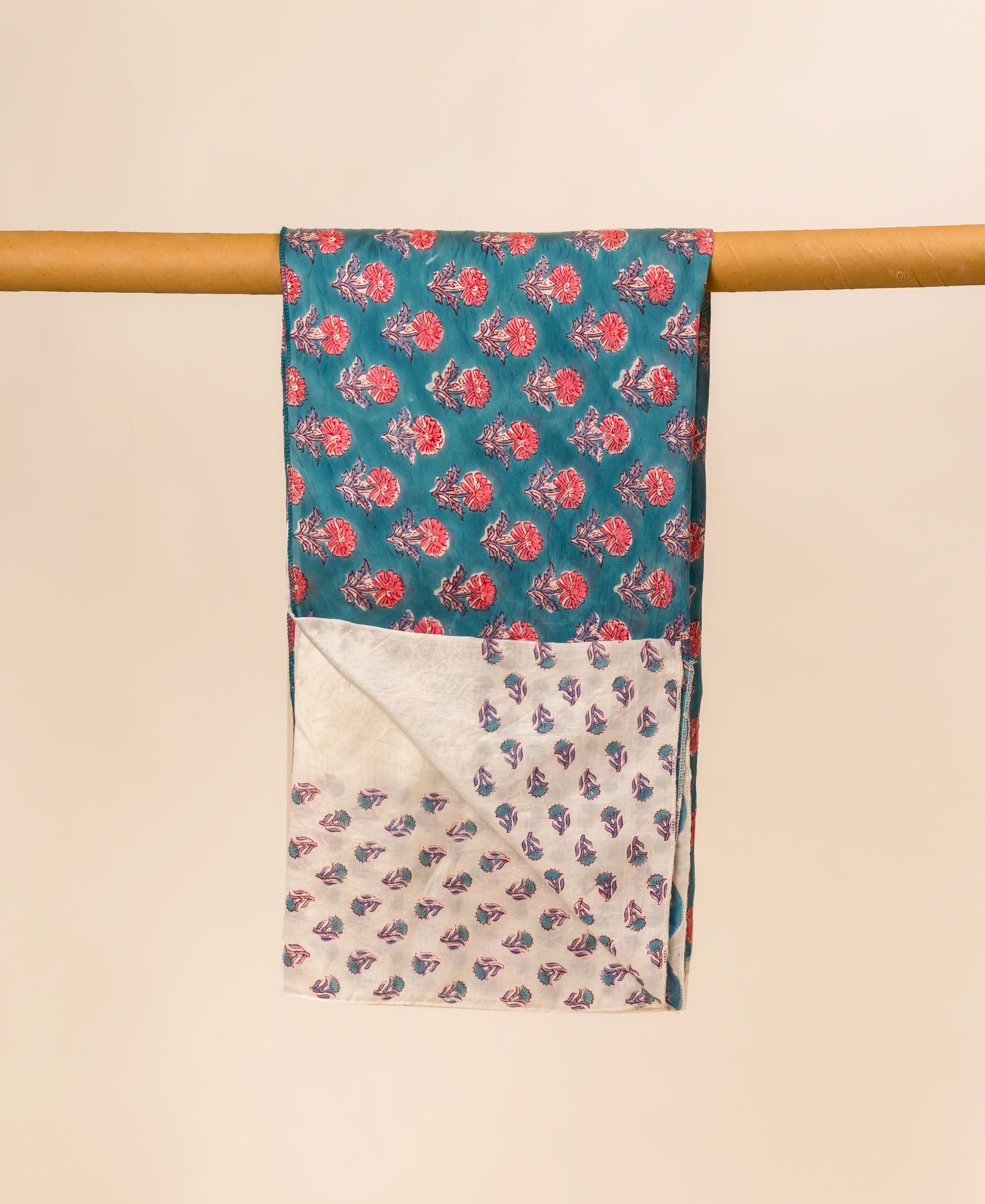 Teal blue hand block printed chanderi dupatta with pink floral and leaf patterns.