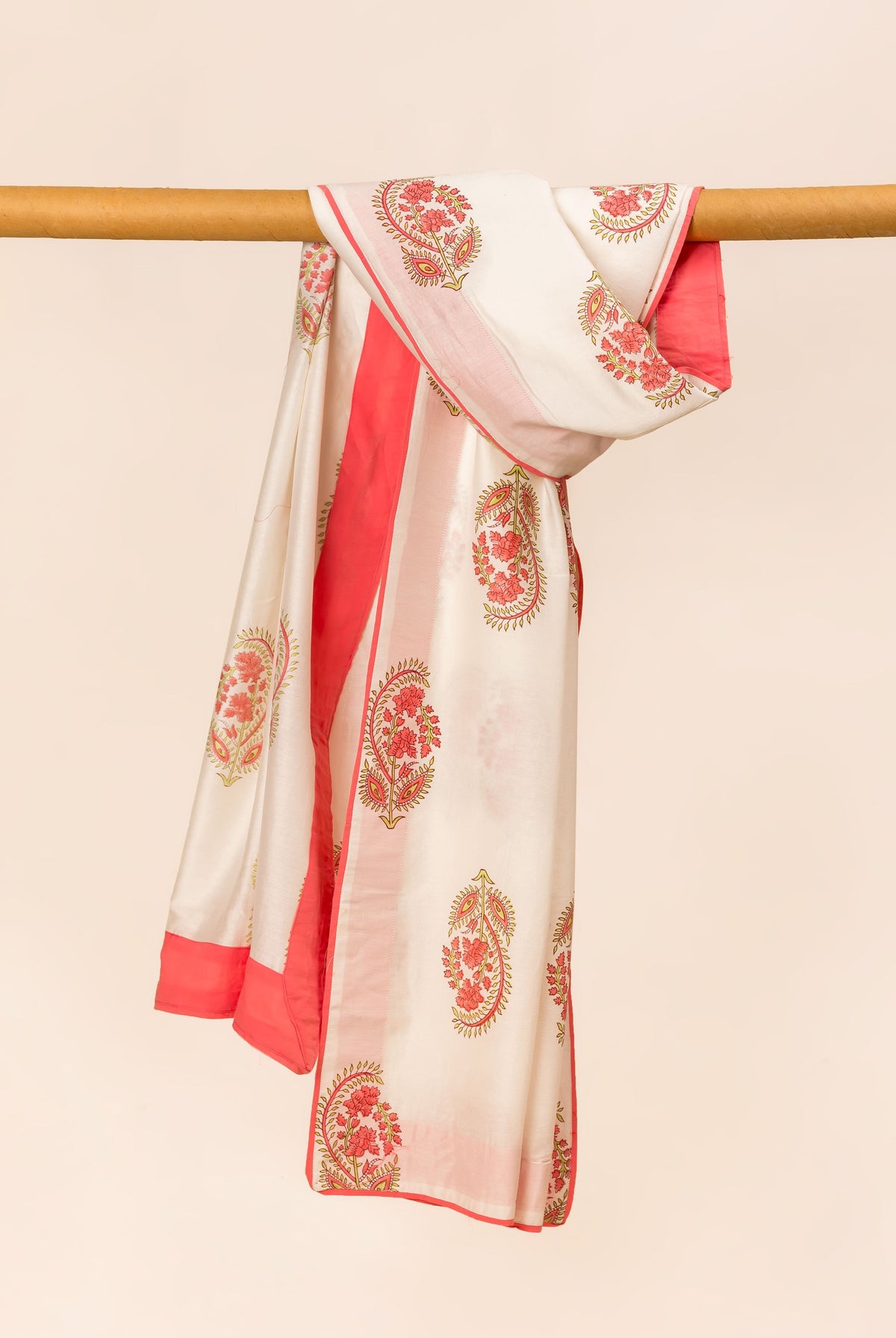 White hand block printed dupatta with red floral patterns and solid red trim, draped.