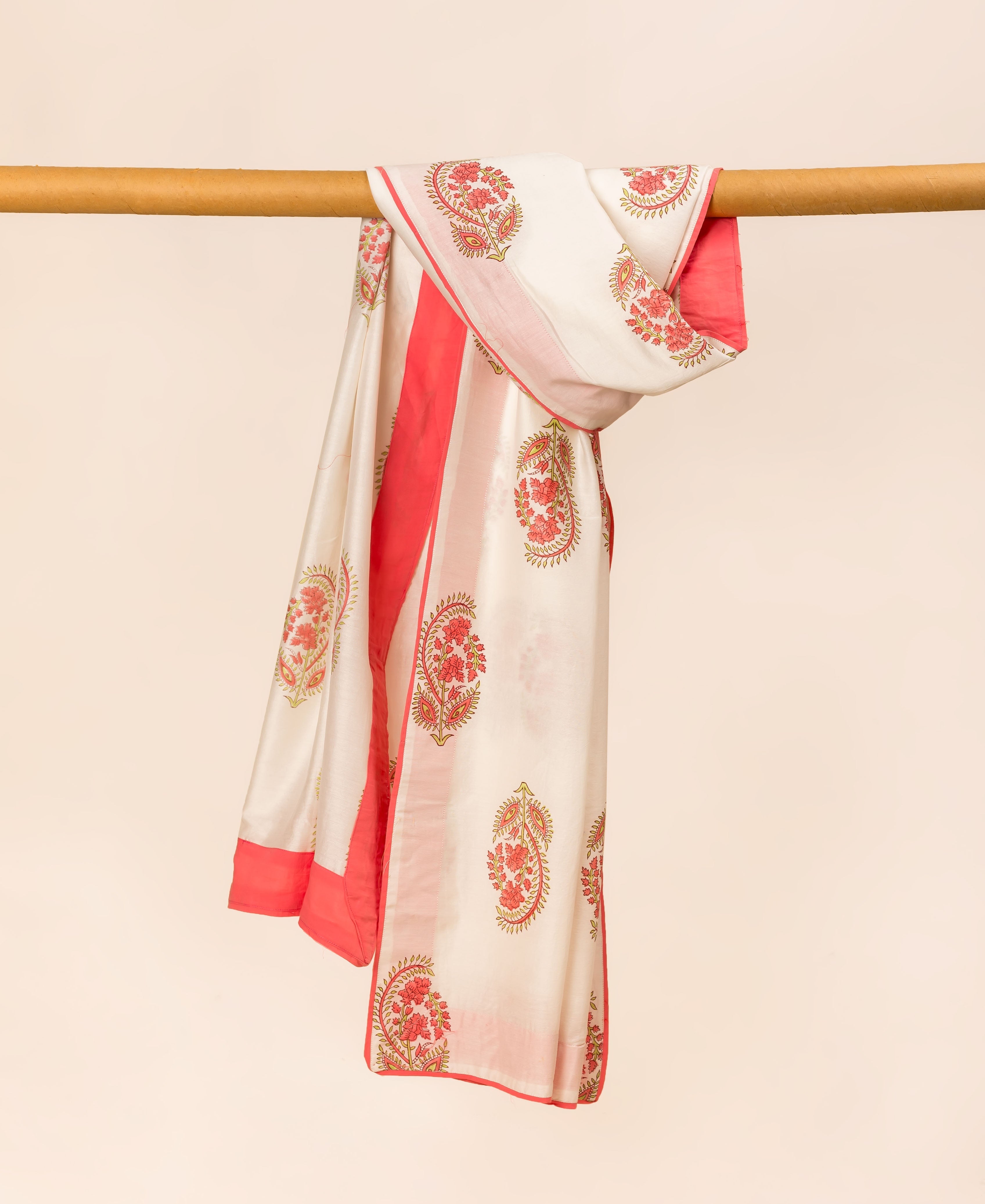 White hand block printed dupatta with red floral patterns and solid red trim, draped.