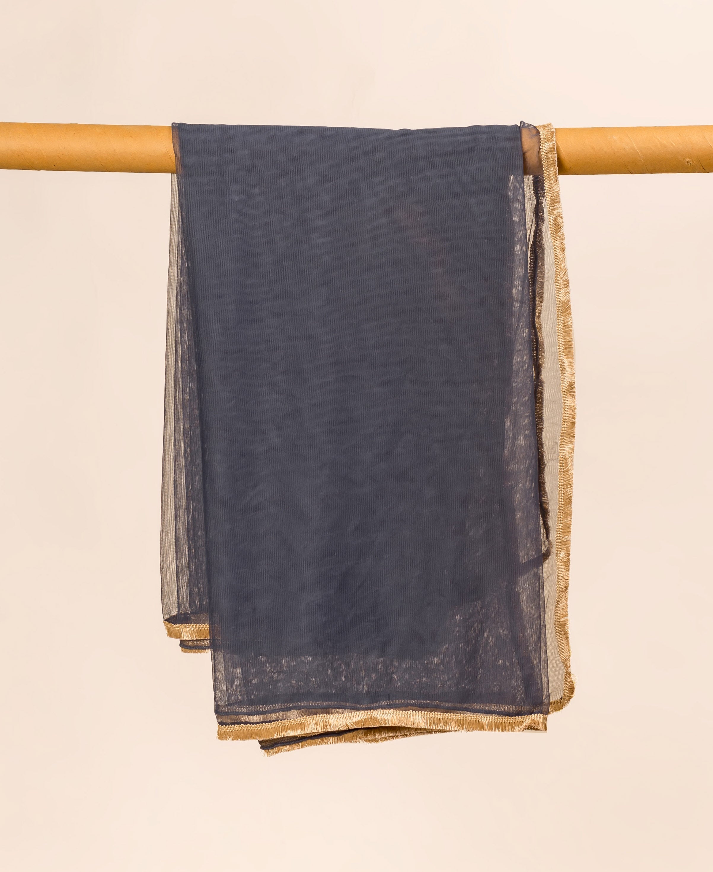 Grey net dupatta with gold trim, folded and hanging on a wooden dowel.