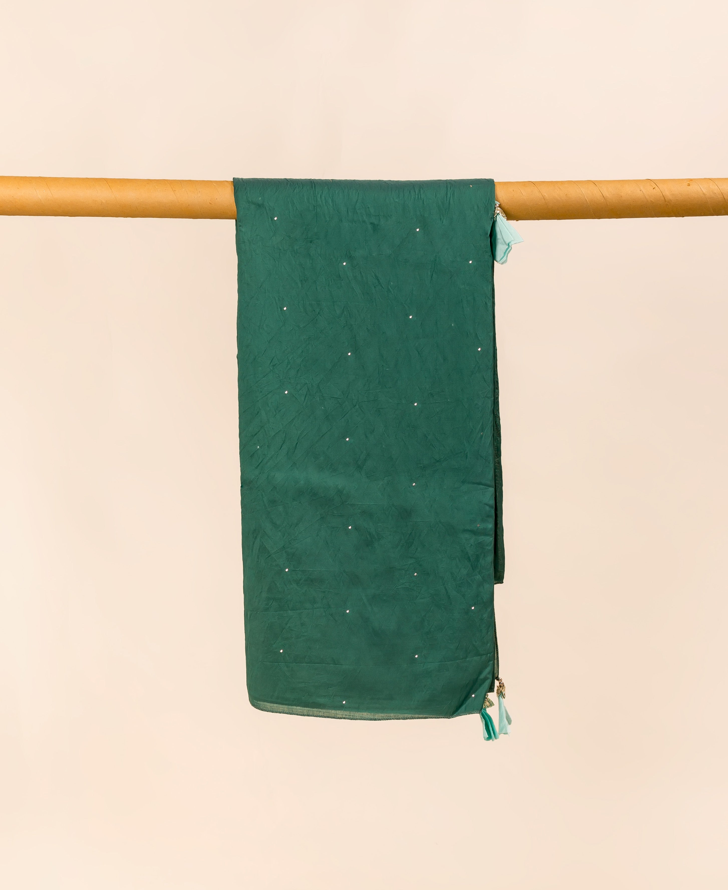 Teal green dupatta with mukaish print, draped over a wooden pole.