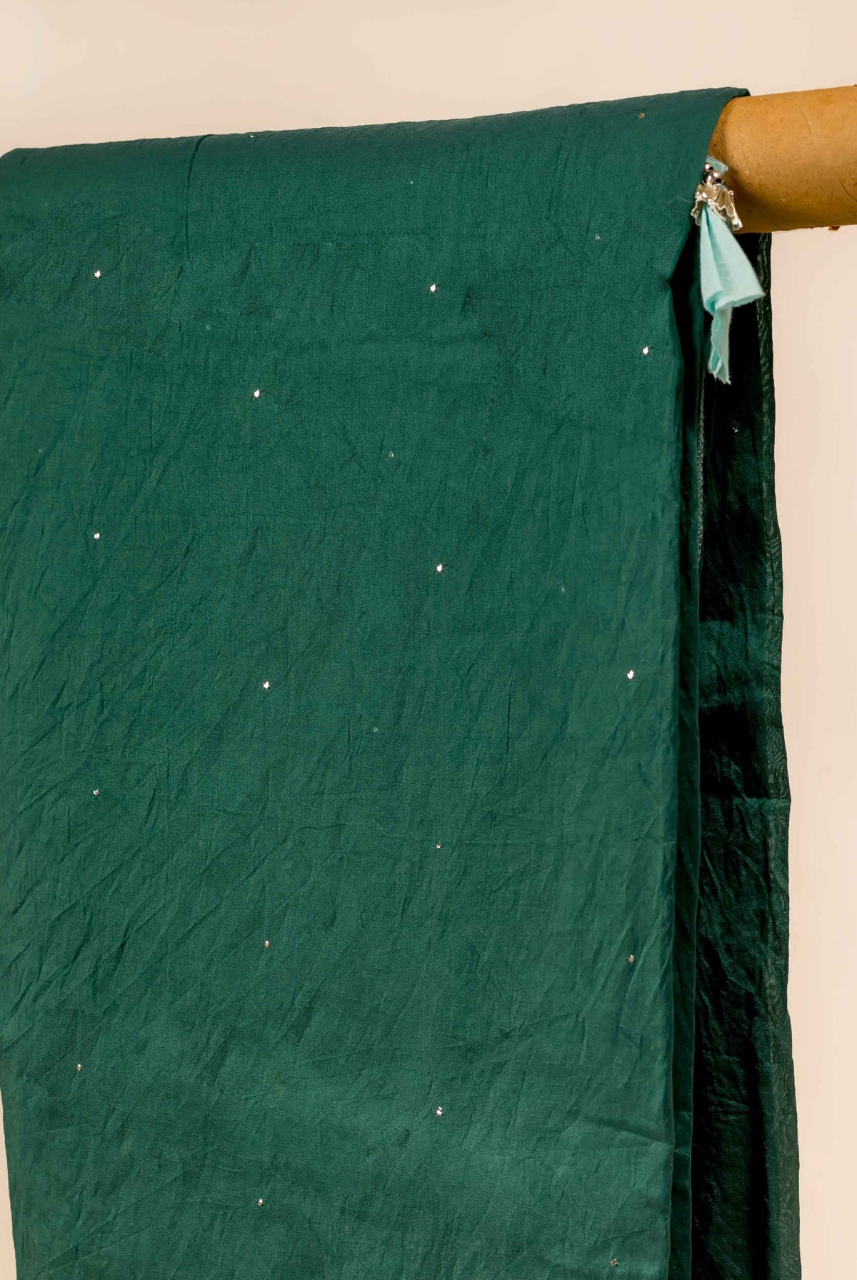 Crinkled teal green Chanderi dupatta, draped with scattered sparkling mukaish dots.