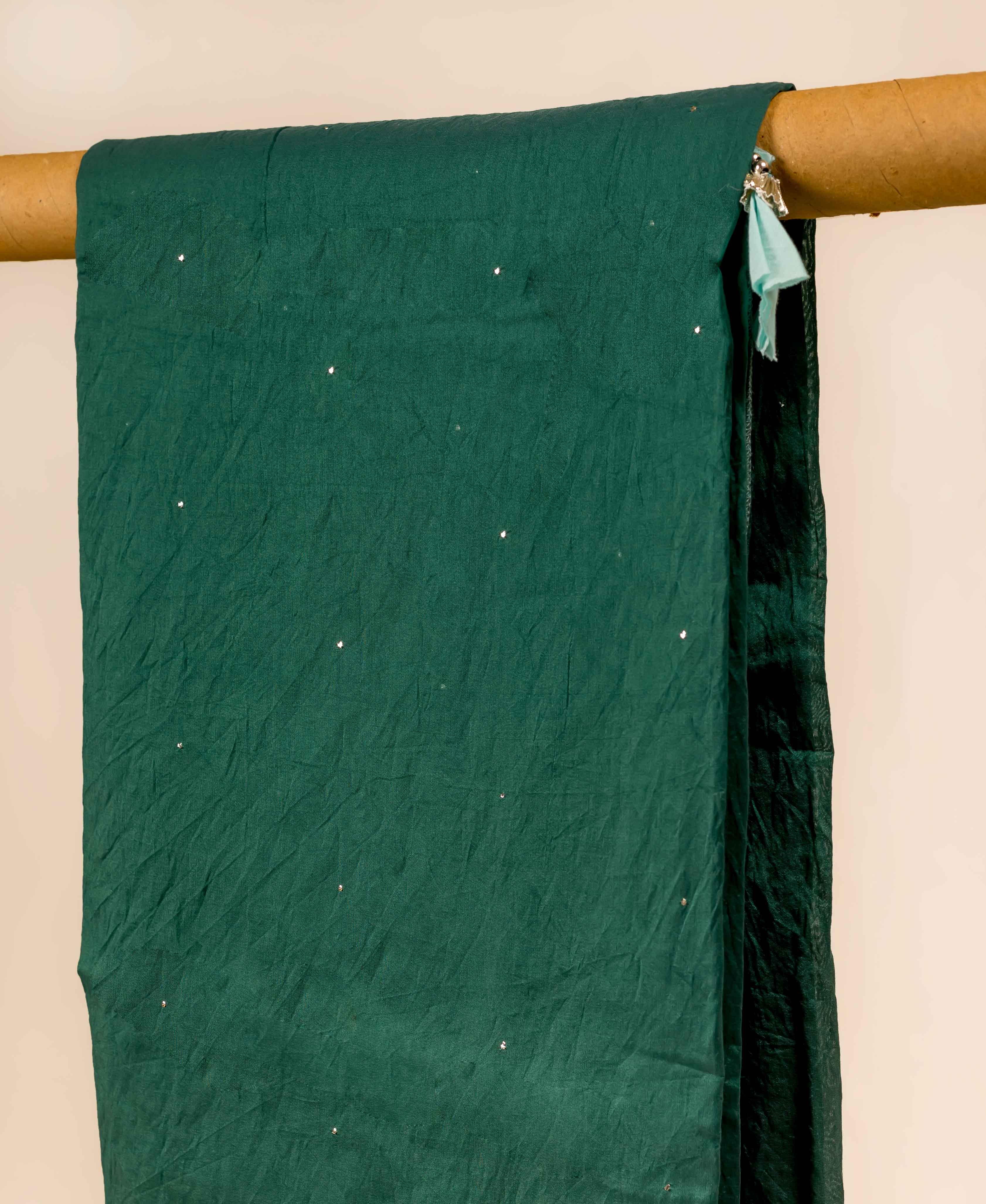 Crinkled teal green Chanderi dupatta, draped with scattered sparkling mukaish dots.
