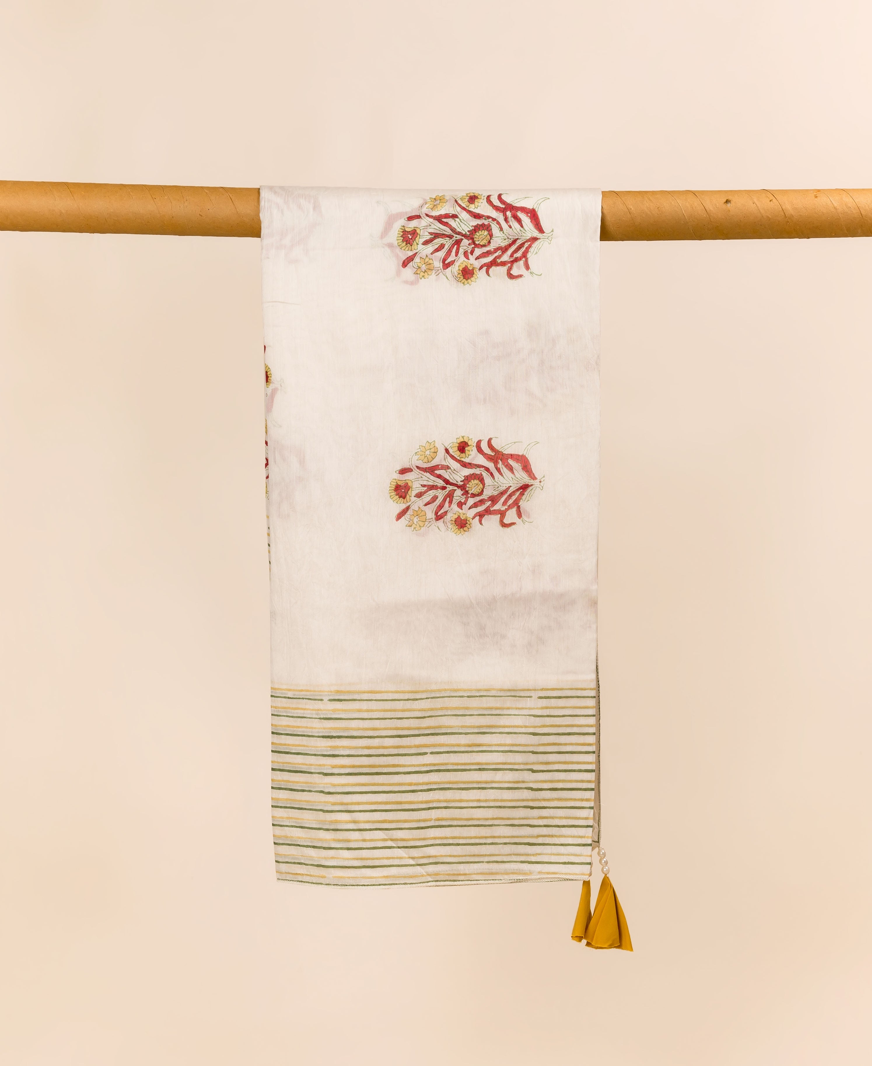 White hand block printed dupatta with red-yellow florals, green stripes, and mustard tassels.