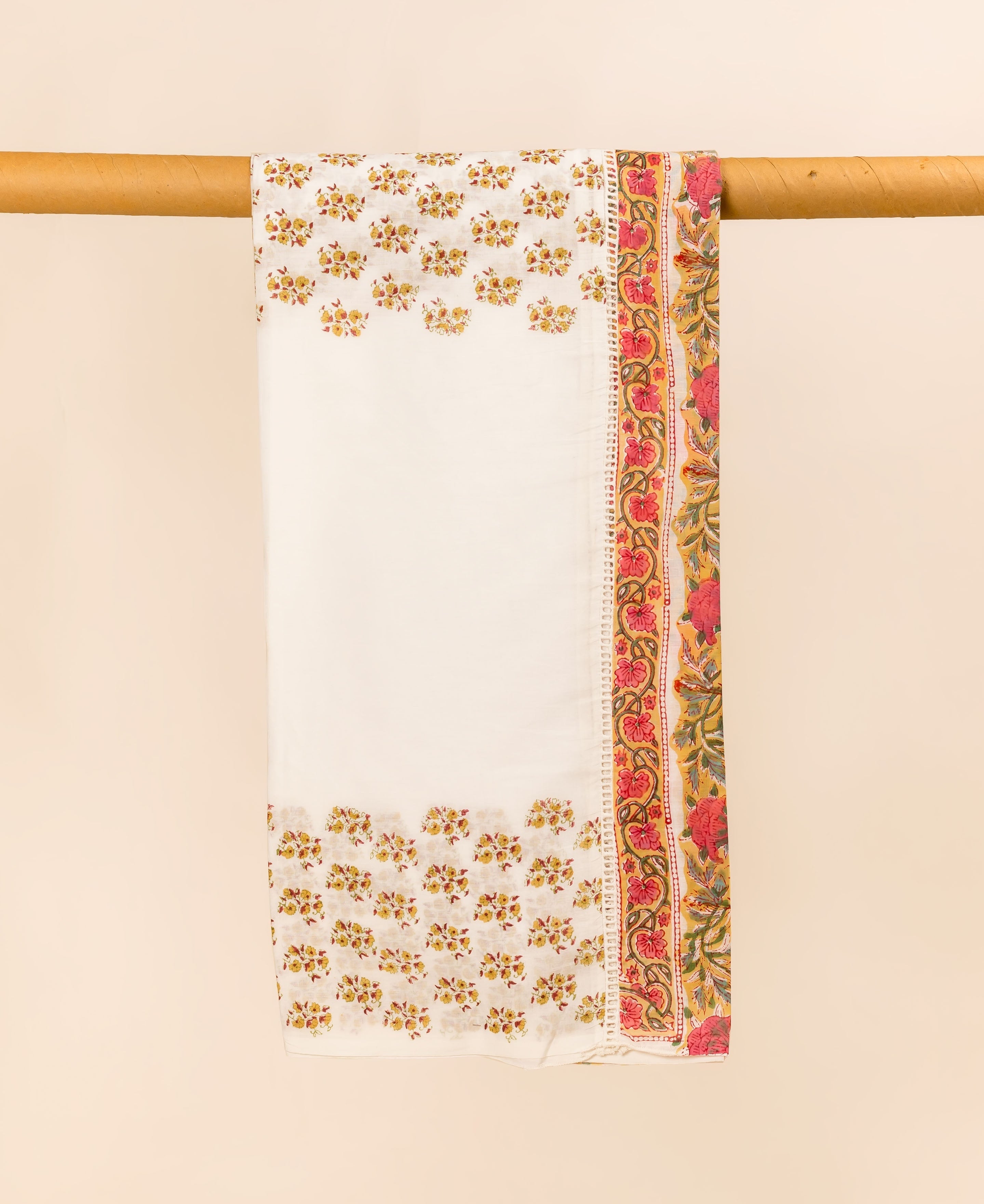 White mul cotton dupatta with yellow floral prints and a vibrant red-yellow floral border, draped.