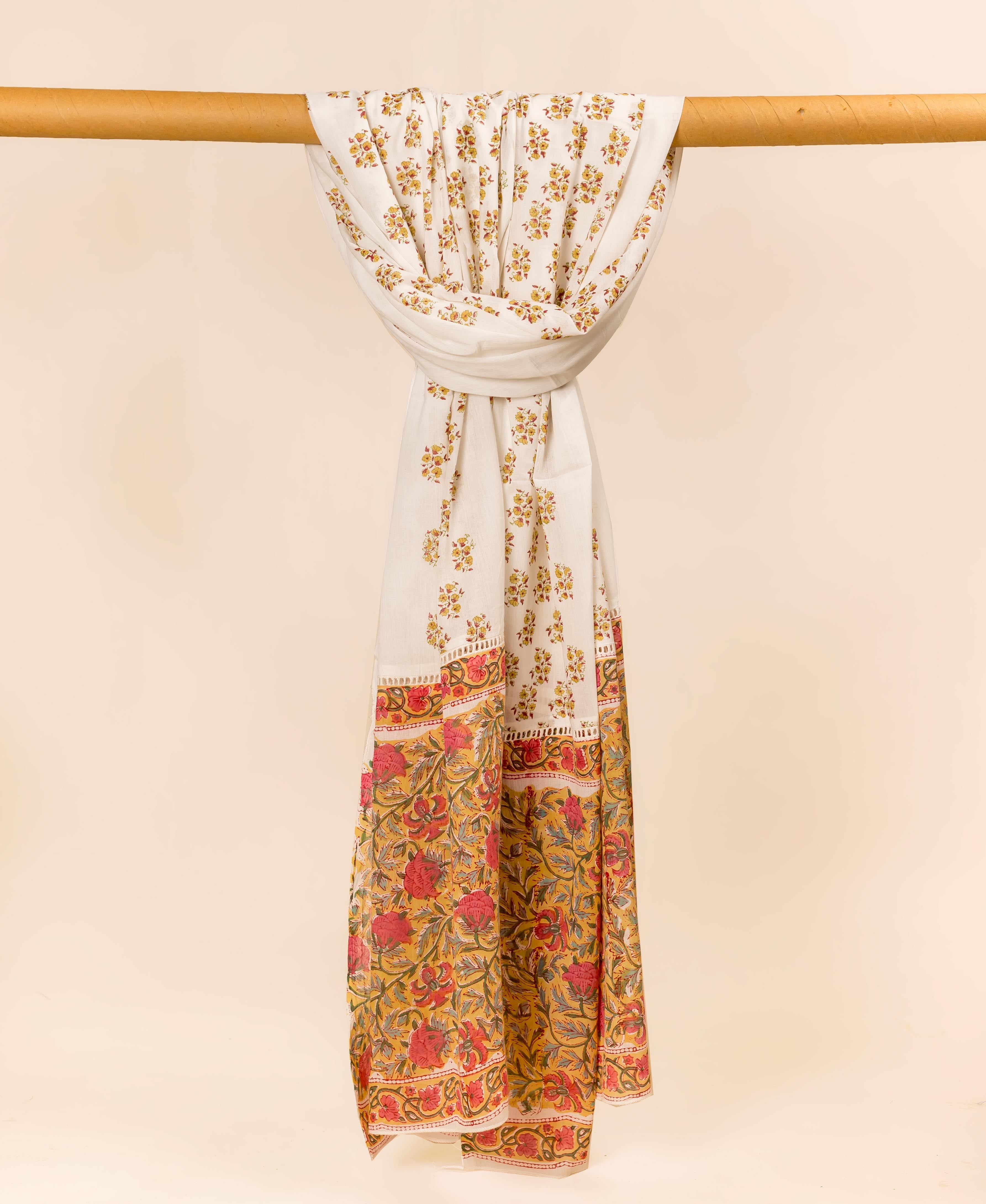 Full-length off-white mul cotton dupatta draped, showcasing delicate yellow flowers and a bold red floral border.