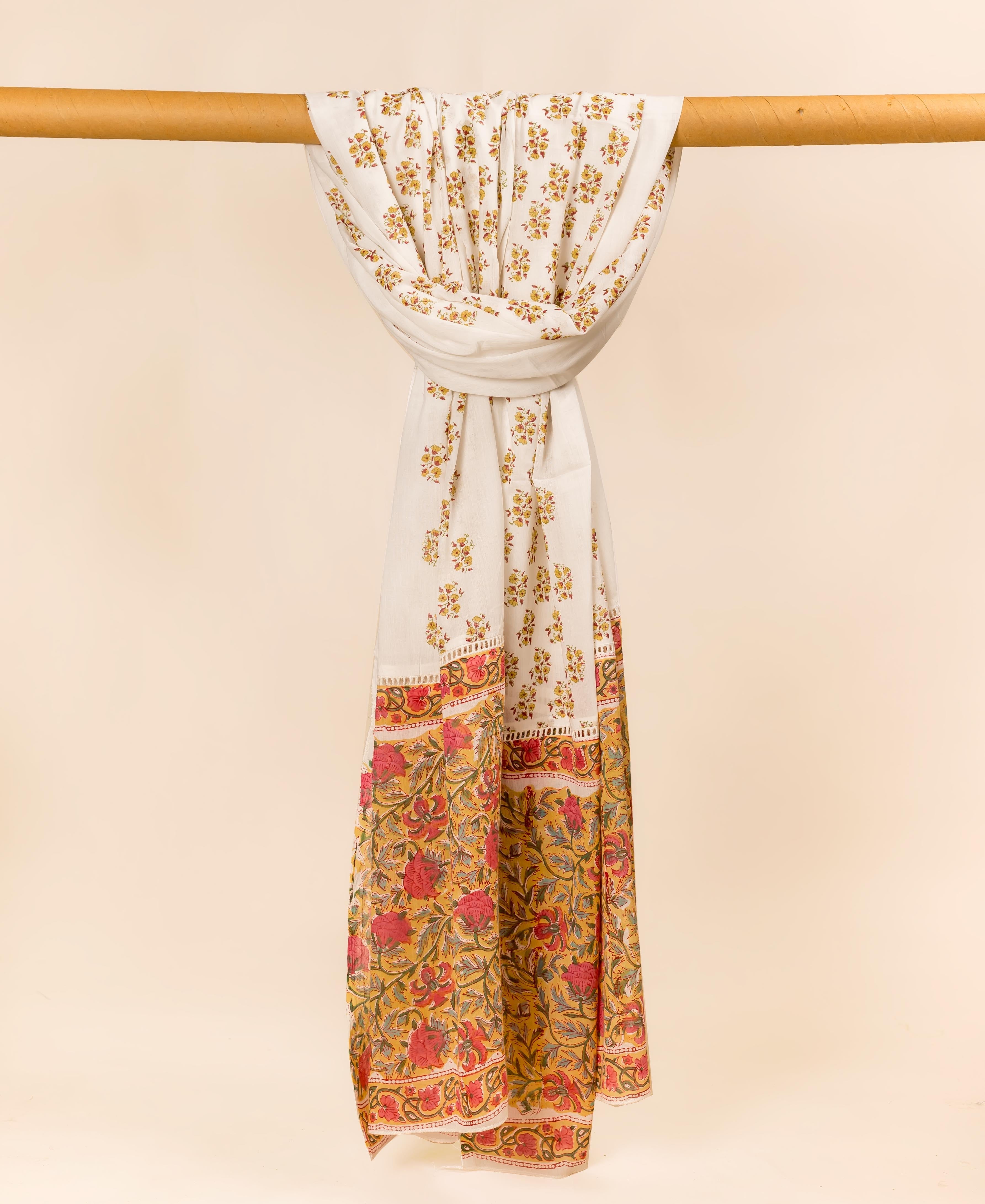 Full-length off-white mul cotton dupatta draped, showcasing delicate yellow flowers and a bold red floral border.