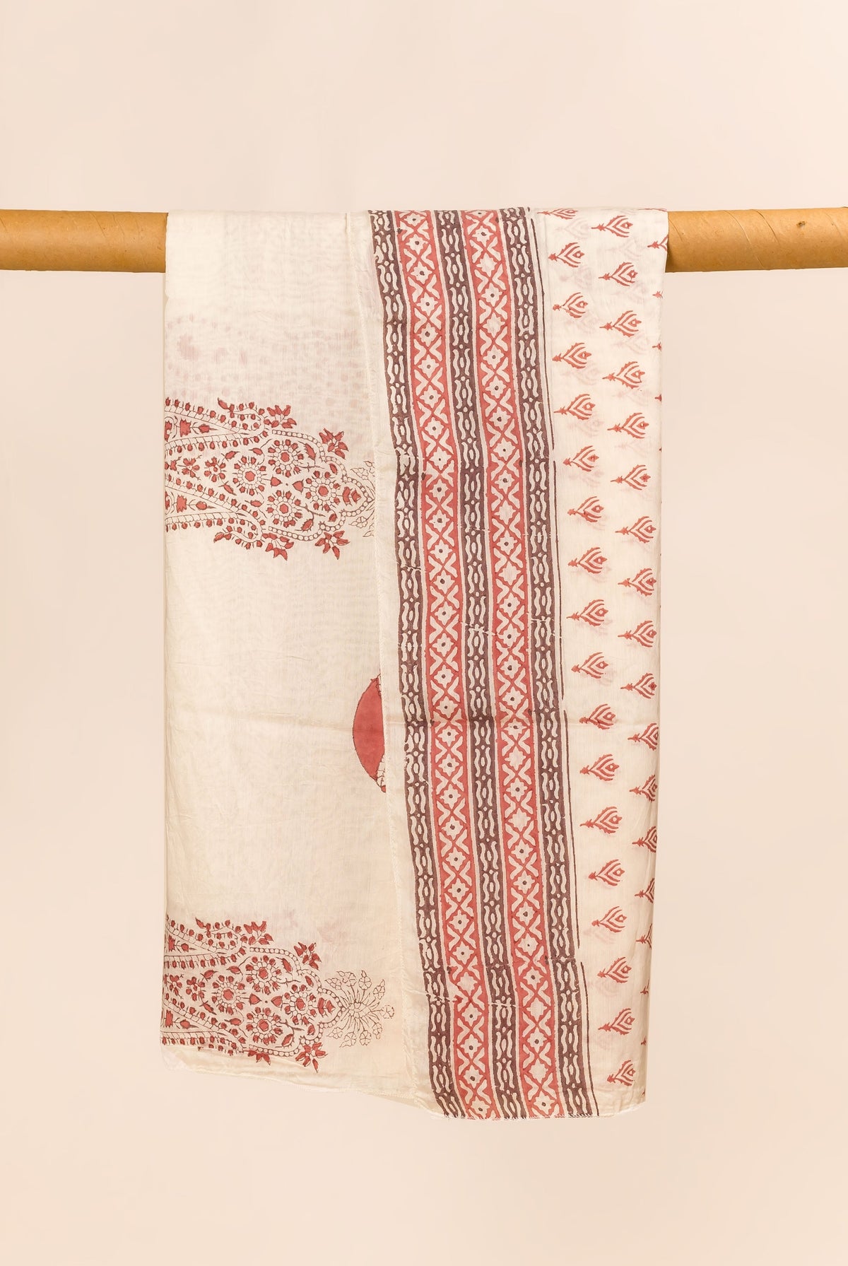 Off-white hand block printed dupatta, draped, with red floral and brown-red geometric patterns.