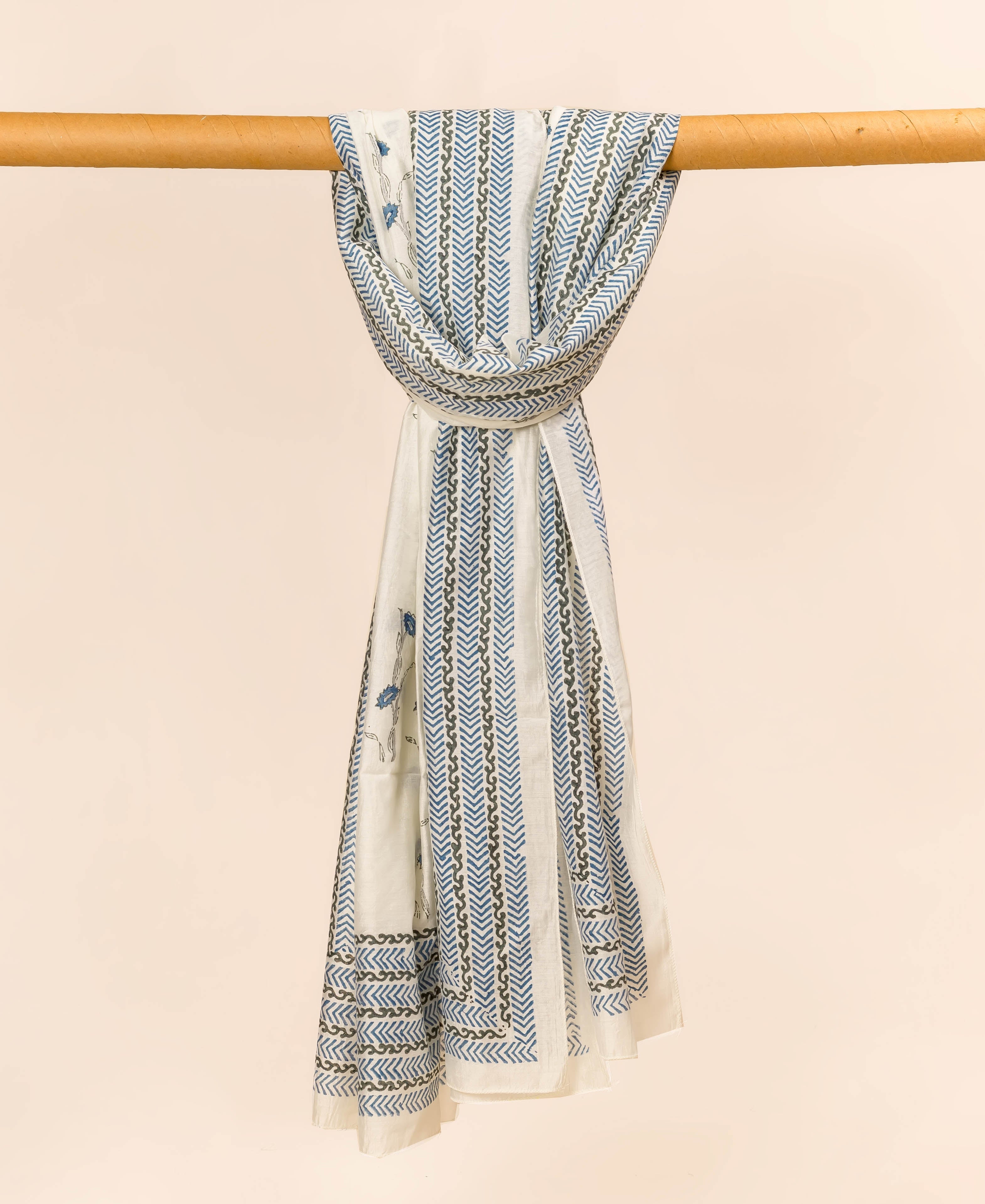 White, mint green and blue hand block printed dupatta, draped with chevron and floral patterns.