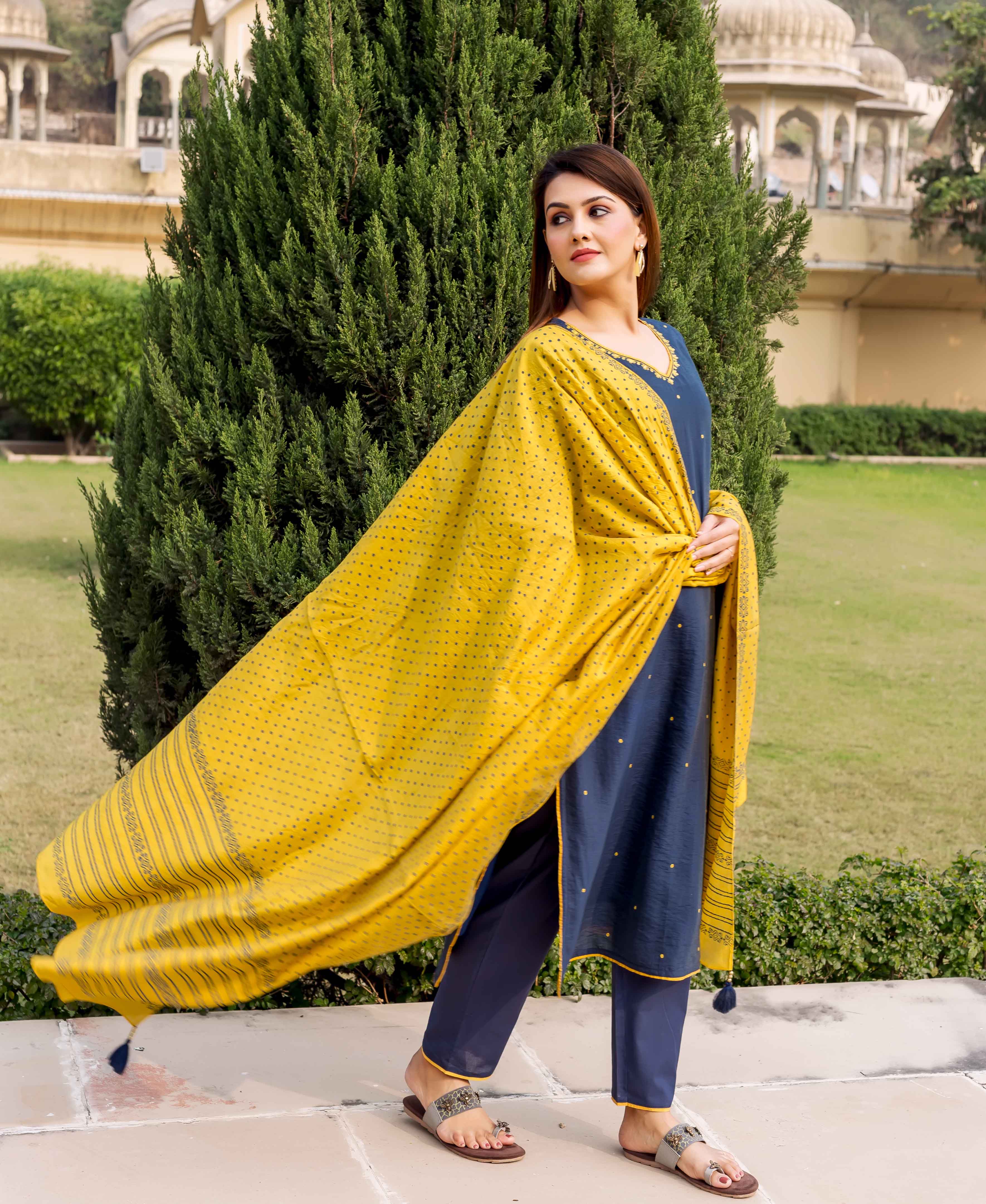 Model in blue kurta set, wearing a flowing yellow hand-block-printed dotted dupatta.