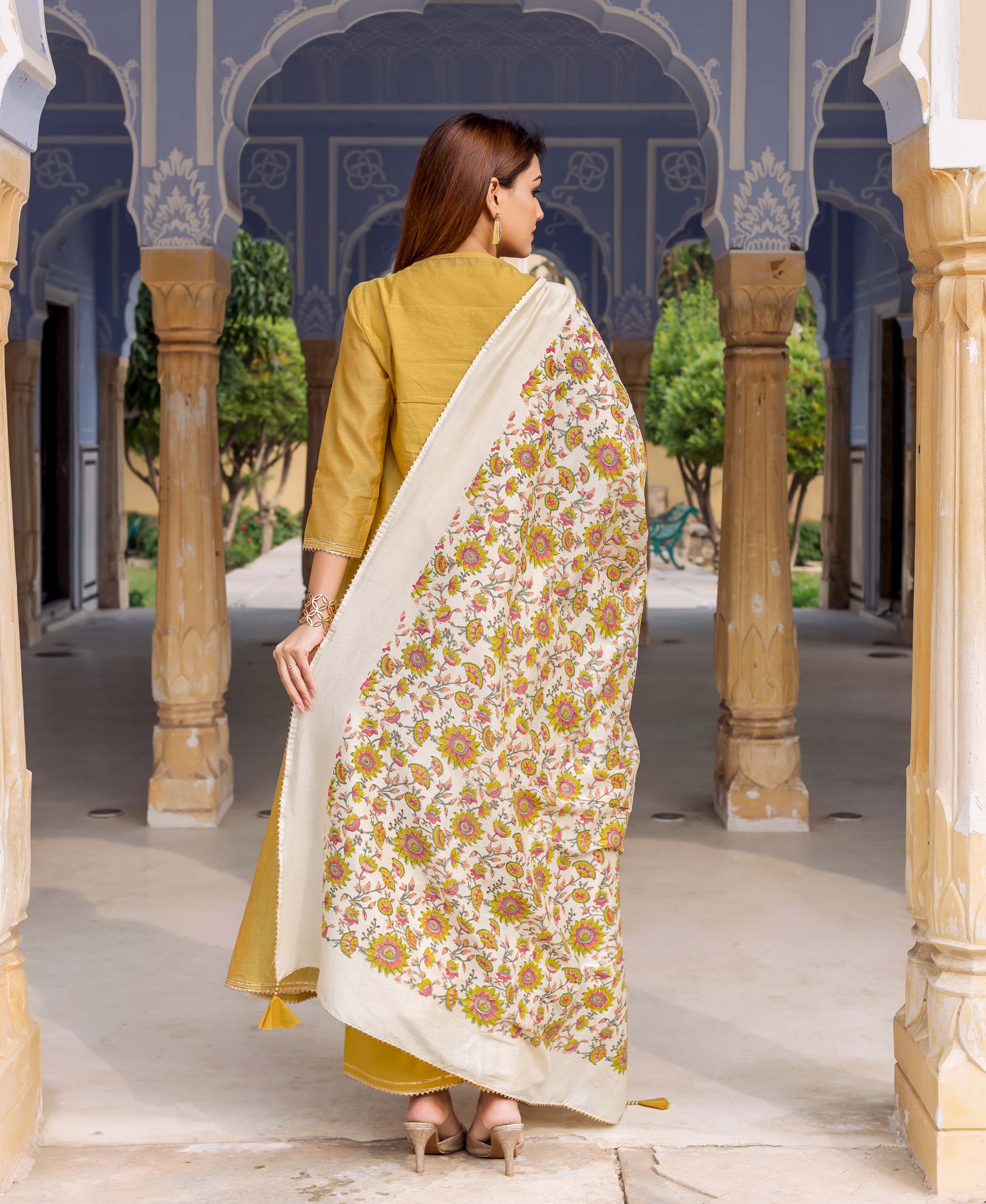 Model from back wearing antique white hand block printed floral dupatta and yellow kurta.