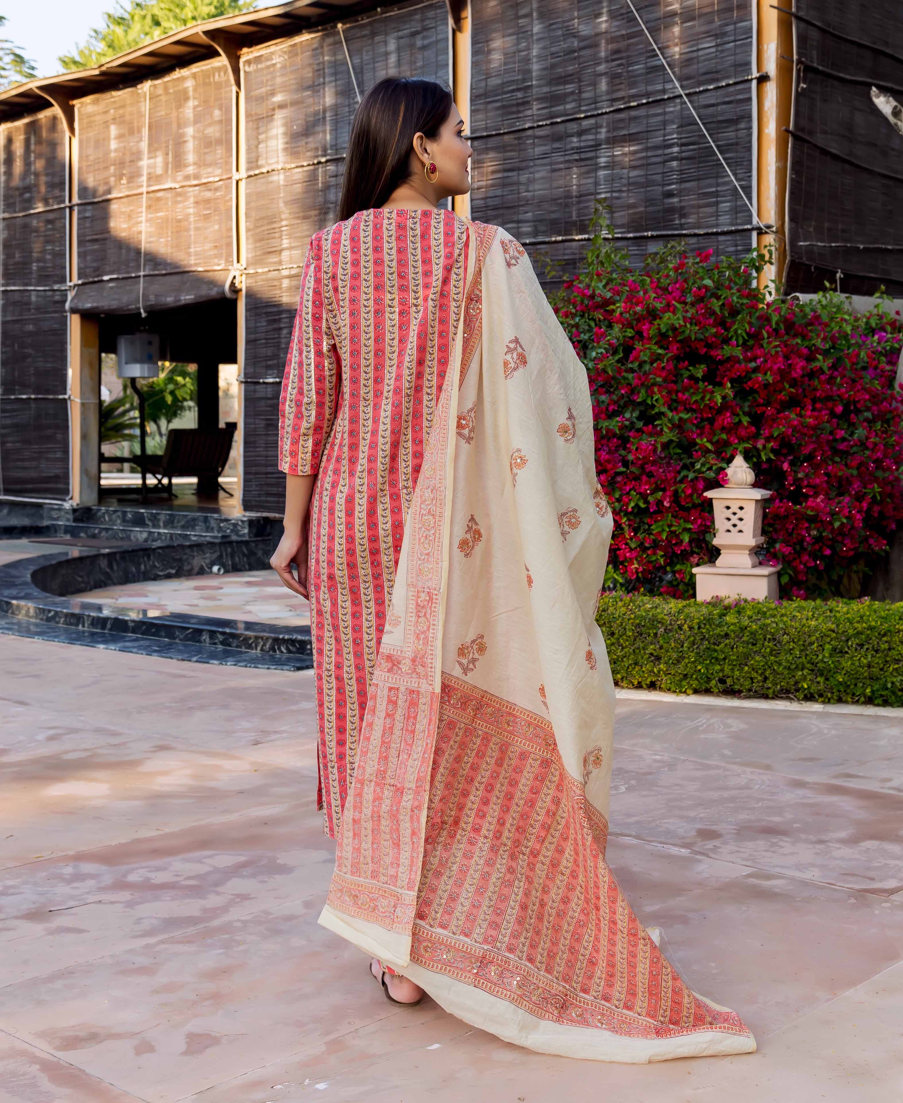 A woman wearing a beige and rust hand block printed dupatta.