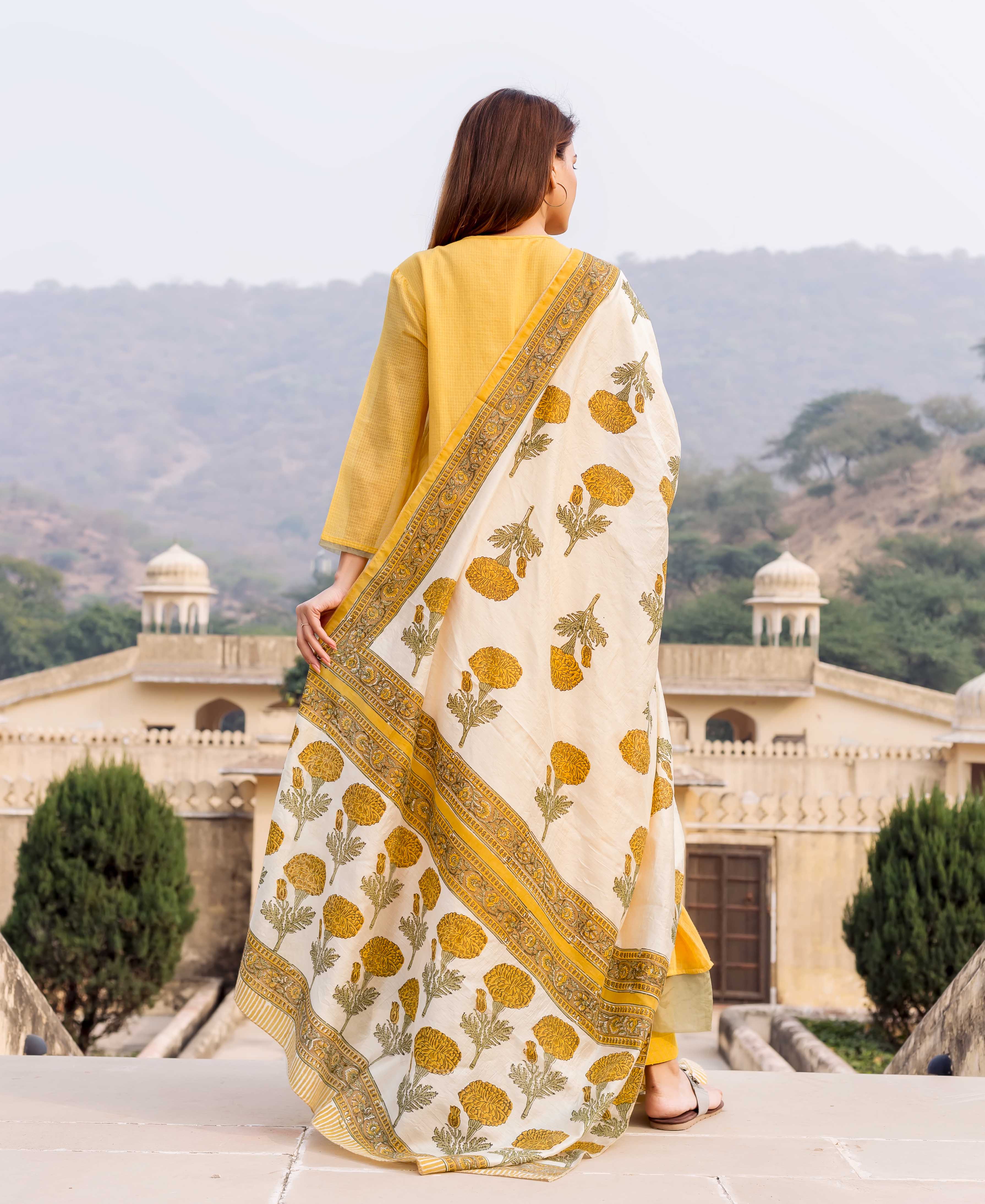 Back view of model in white and yellow marigold hand block printed dupatta.