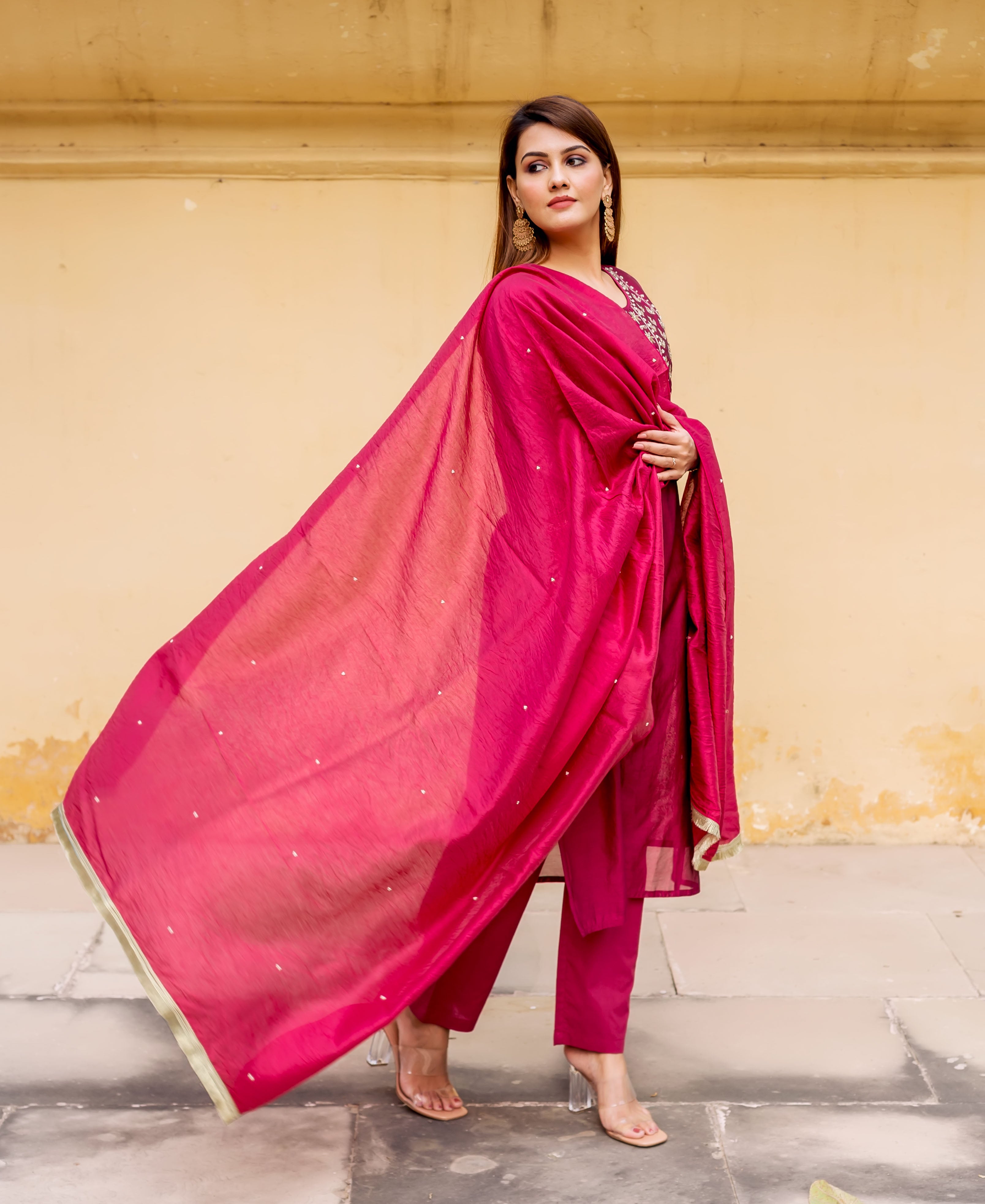 Pink outfit with flowing dupatta, bead work on shoulder, hand-block print not visible.