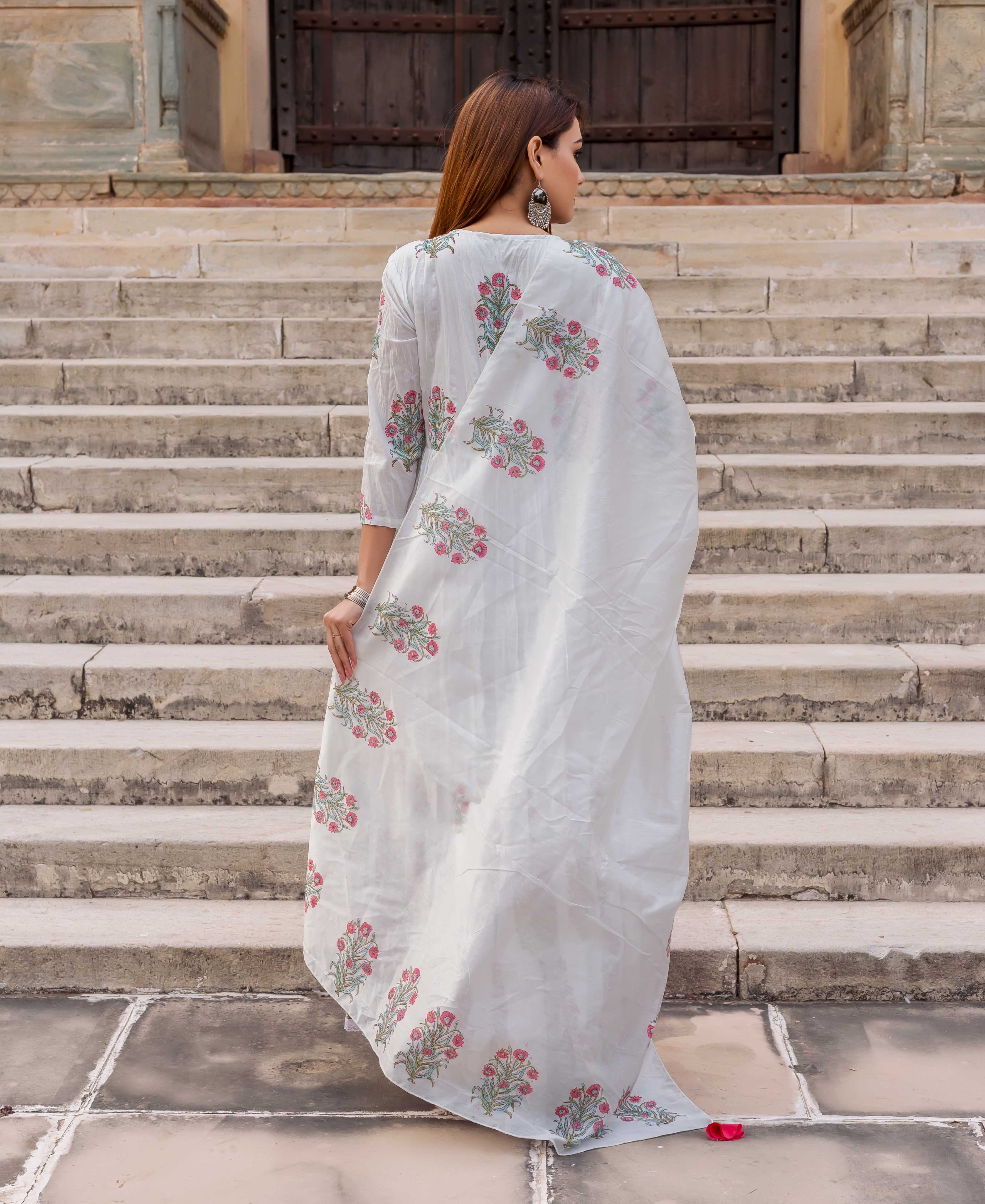 Back view of woman in white hand block printed dupatta with pink and green florals.