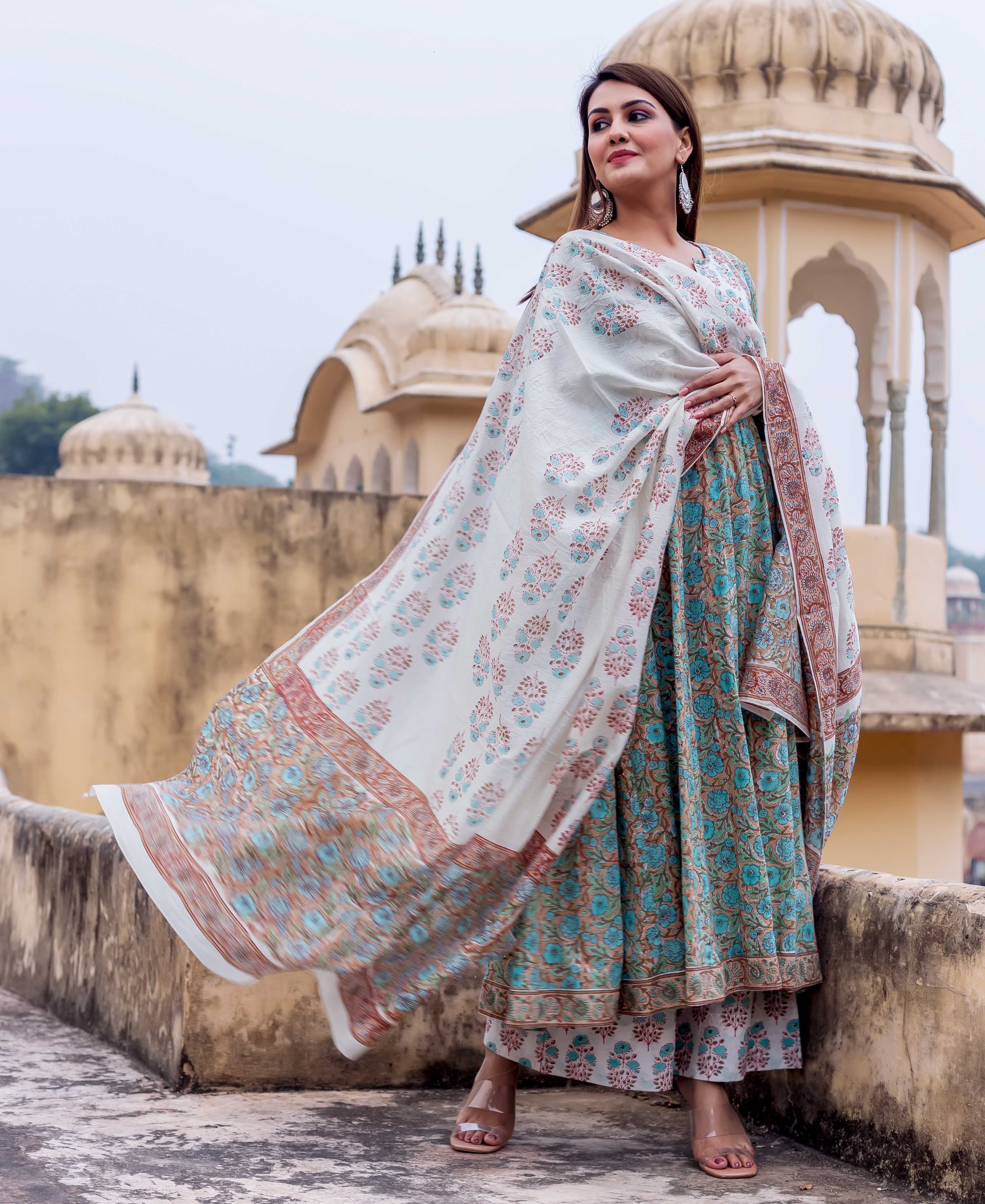 White hand block printed dupatta with rust and blue floral patterns, draped on a model, flowing.