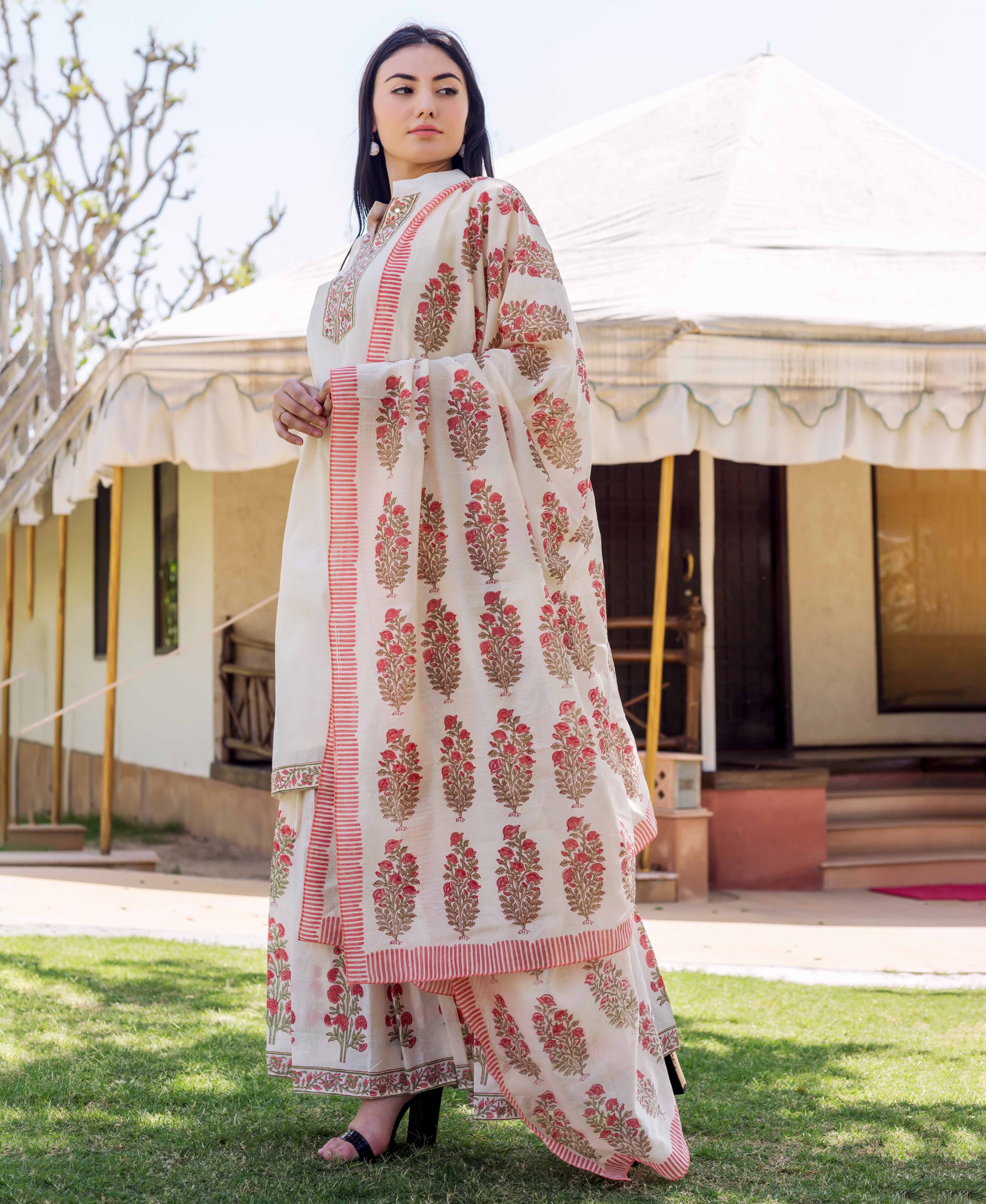 Model showcases ivory hand-block printed Chanderi dupatta with red floral print and striped border.