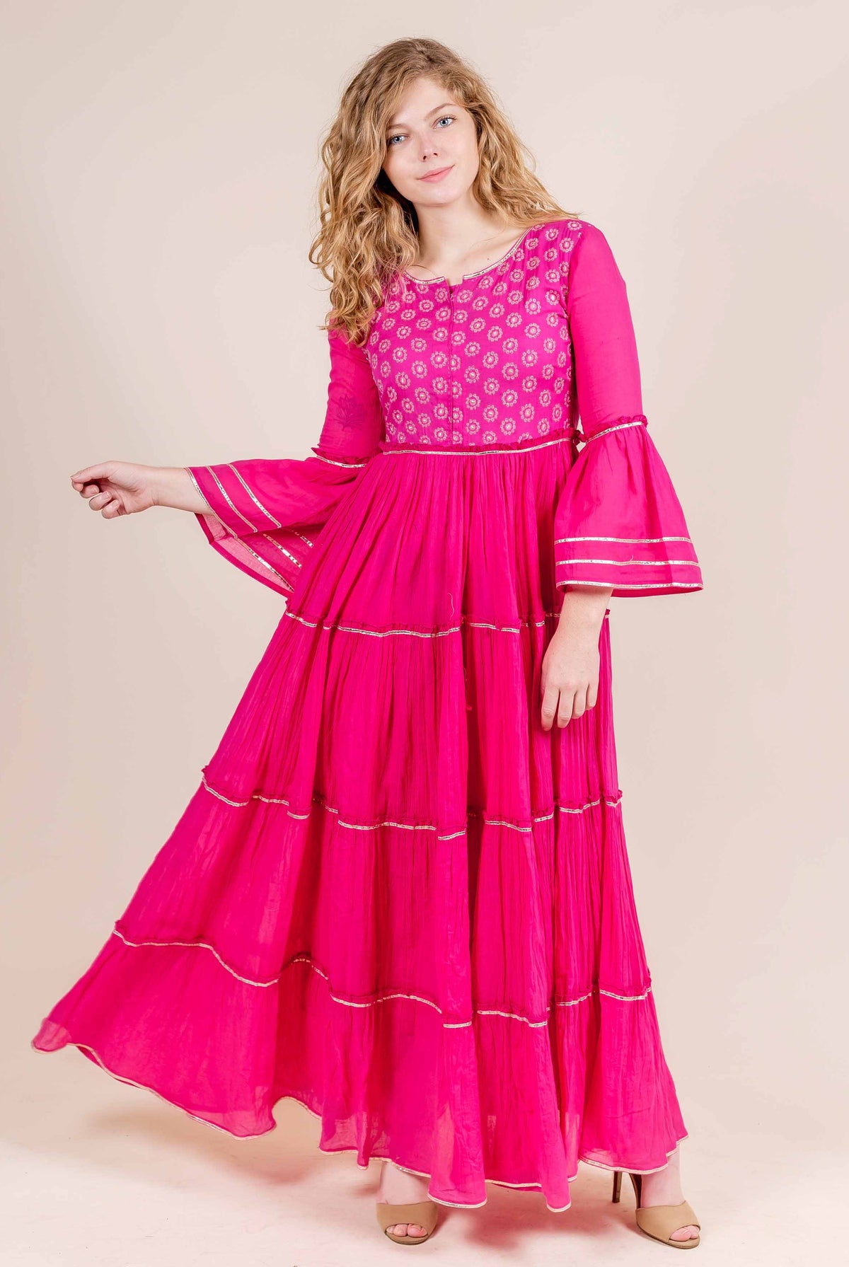 Full look fuchsia tiered cotton dress, hand-block-printed yoke, full bell sleeves with gota trim.