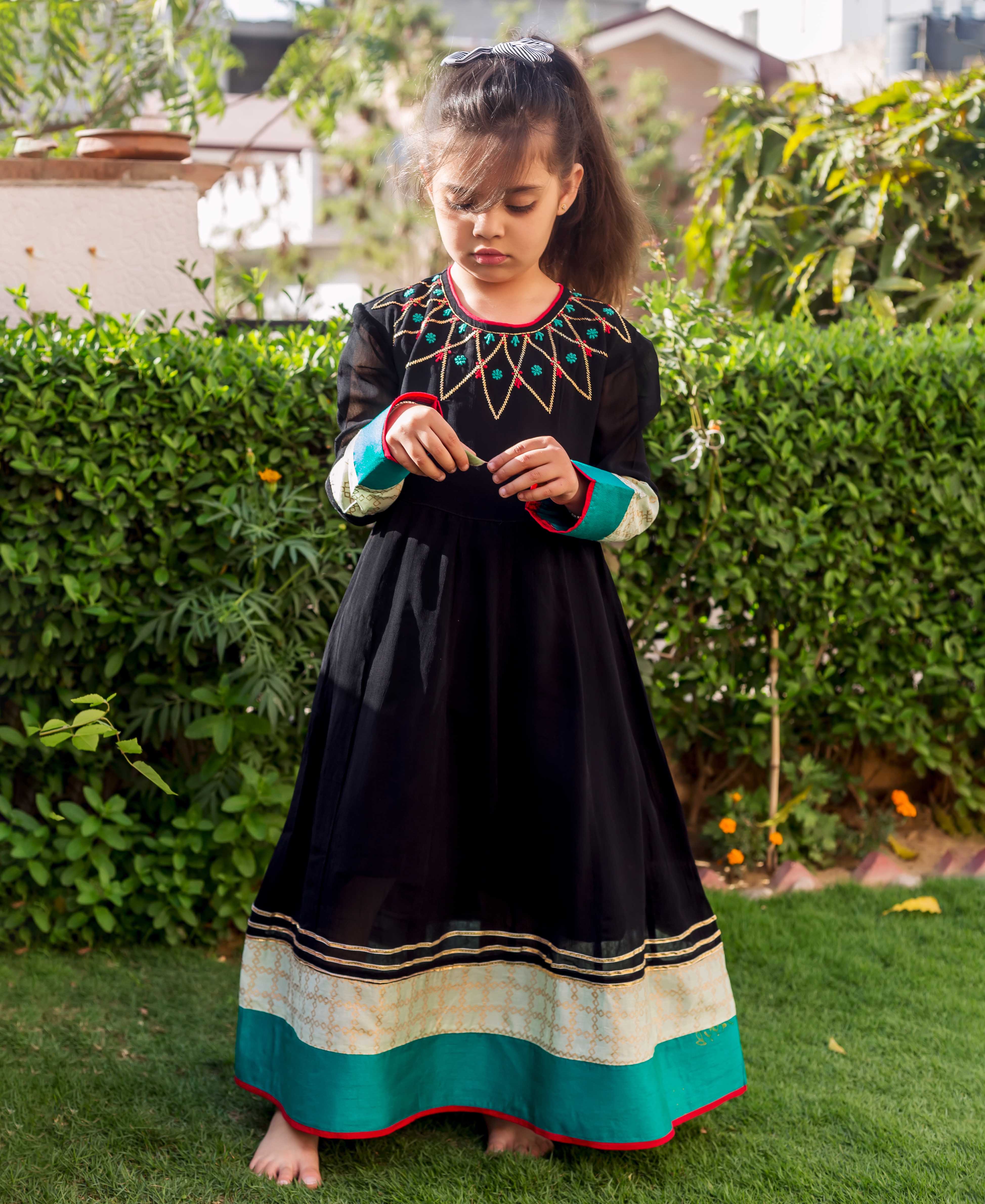 Black and lime Anarkali dress, full look on a model, with embroidered yoke and patterned hem.