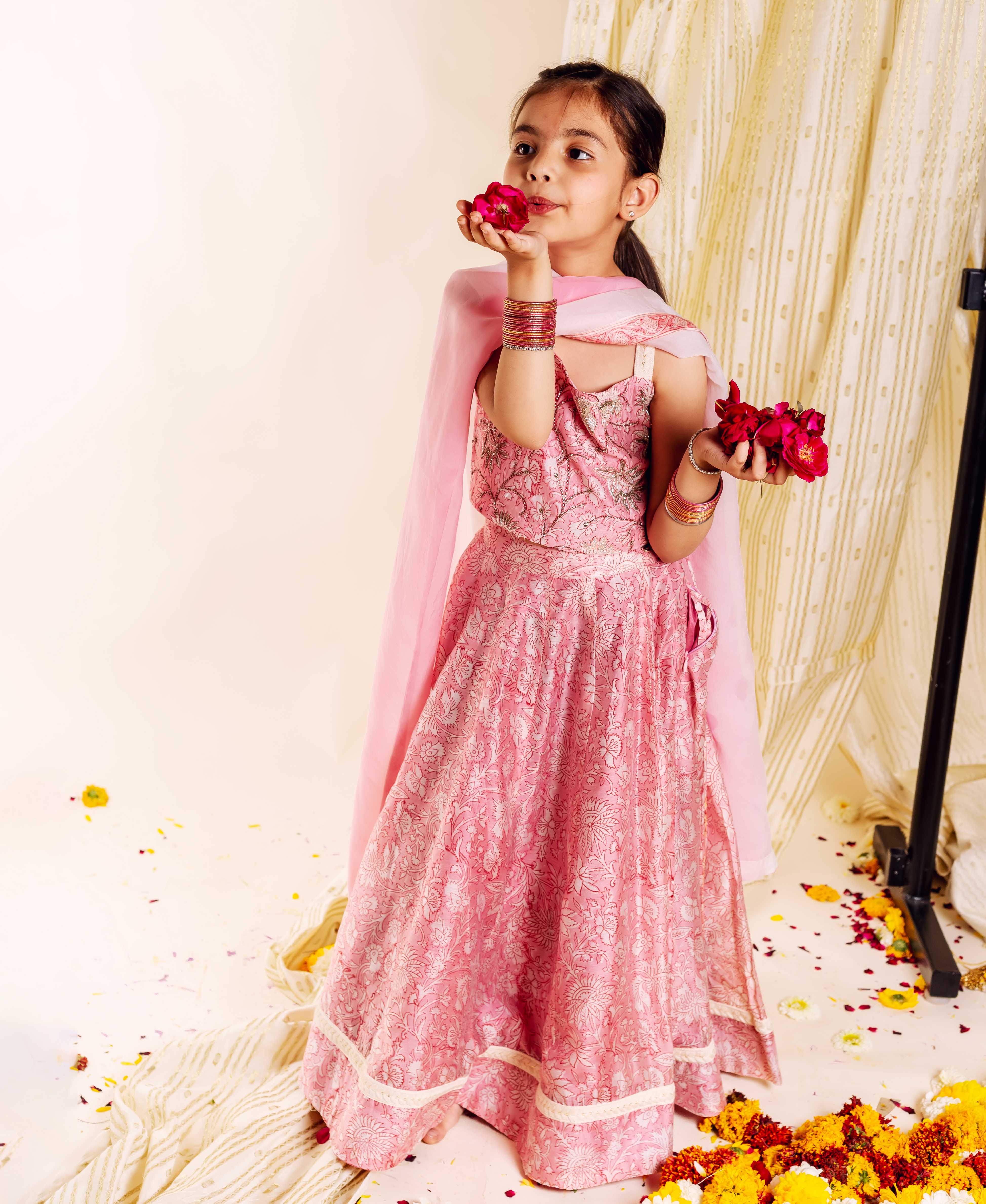 A young girl models a pink Missprint hand-block-printed Mahi Lehenga Set.