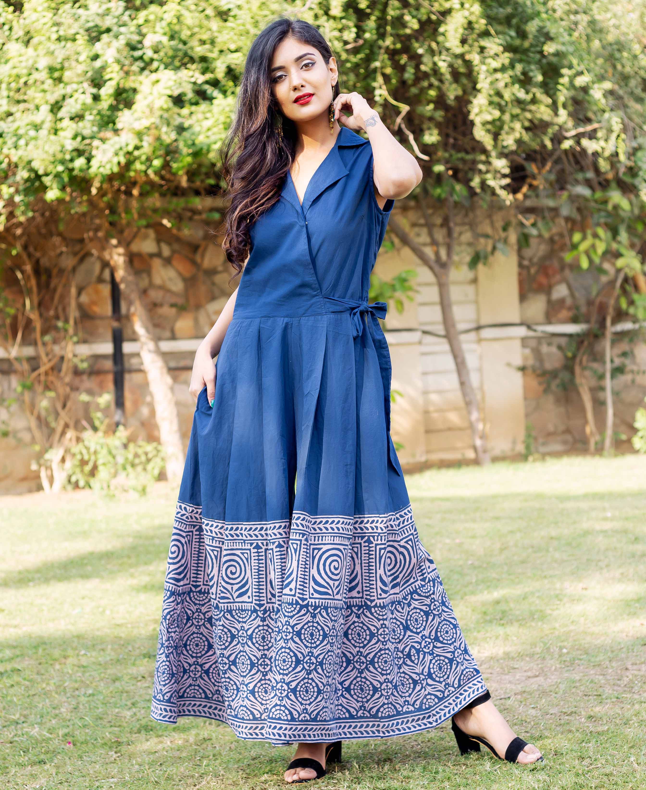 A woman in a blue and white hand-block-printed cotton jumpsuit.