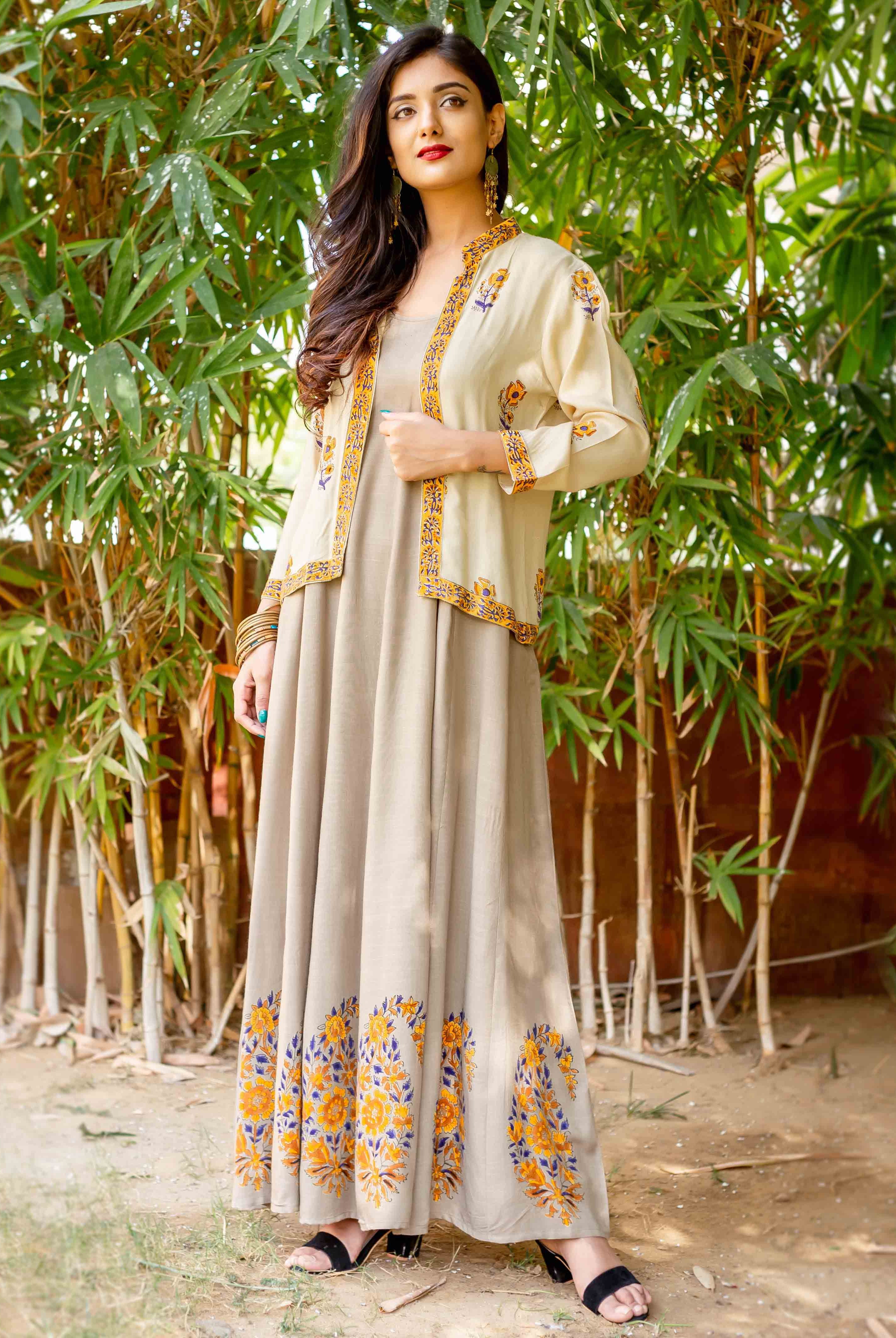 Front view model in beige dress with cream hand-block-printed yellow-blue floral jacket and hem.