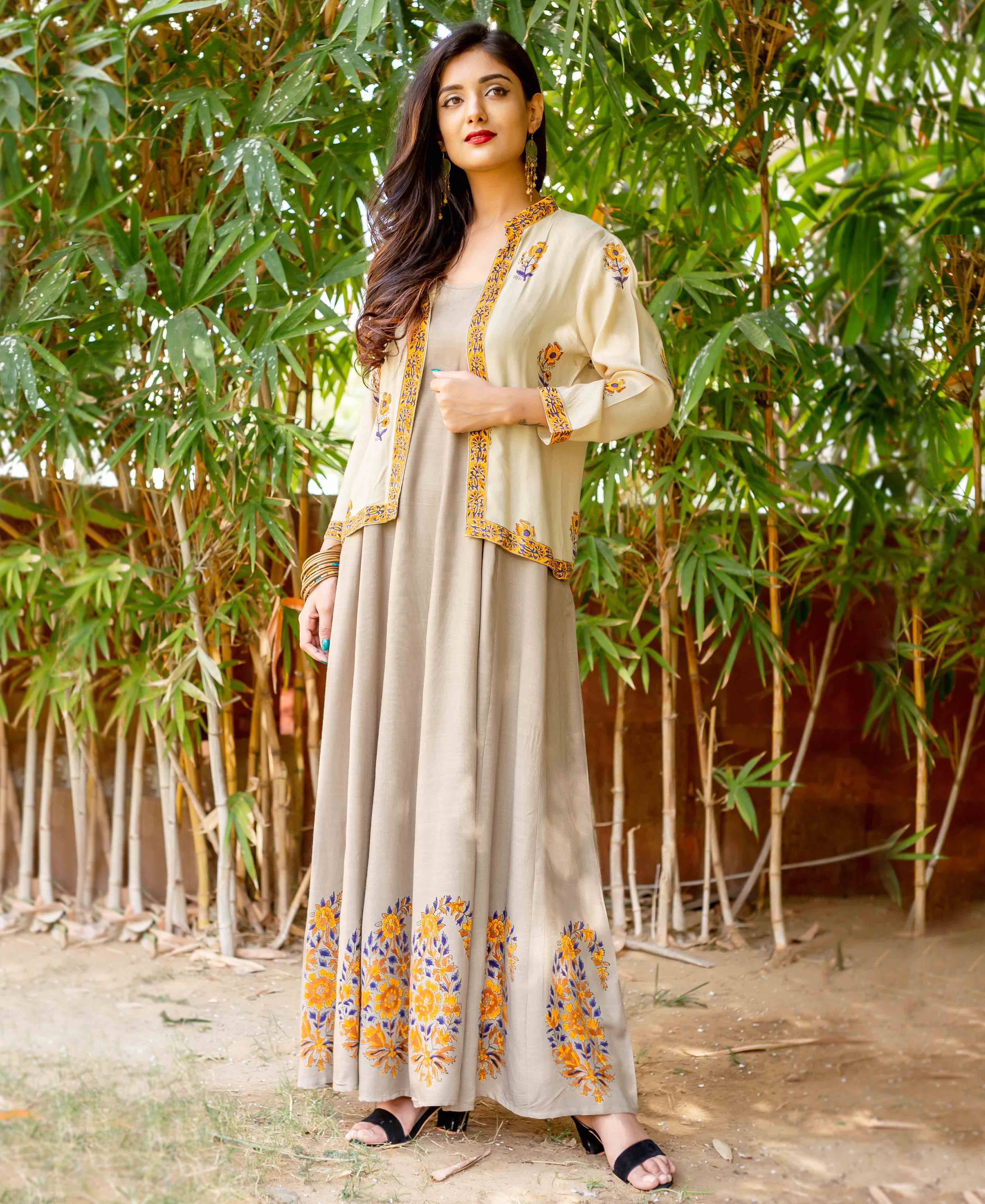 Front view model in beige dress with cream hand-block-printed yellow-blue floral jacket and hem.