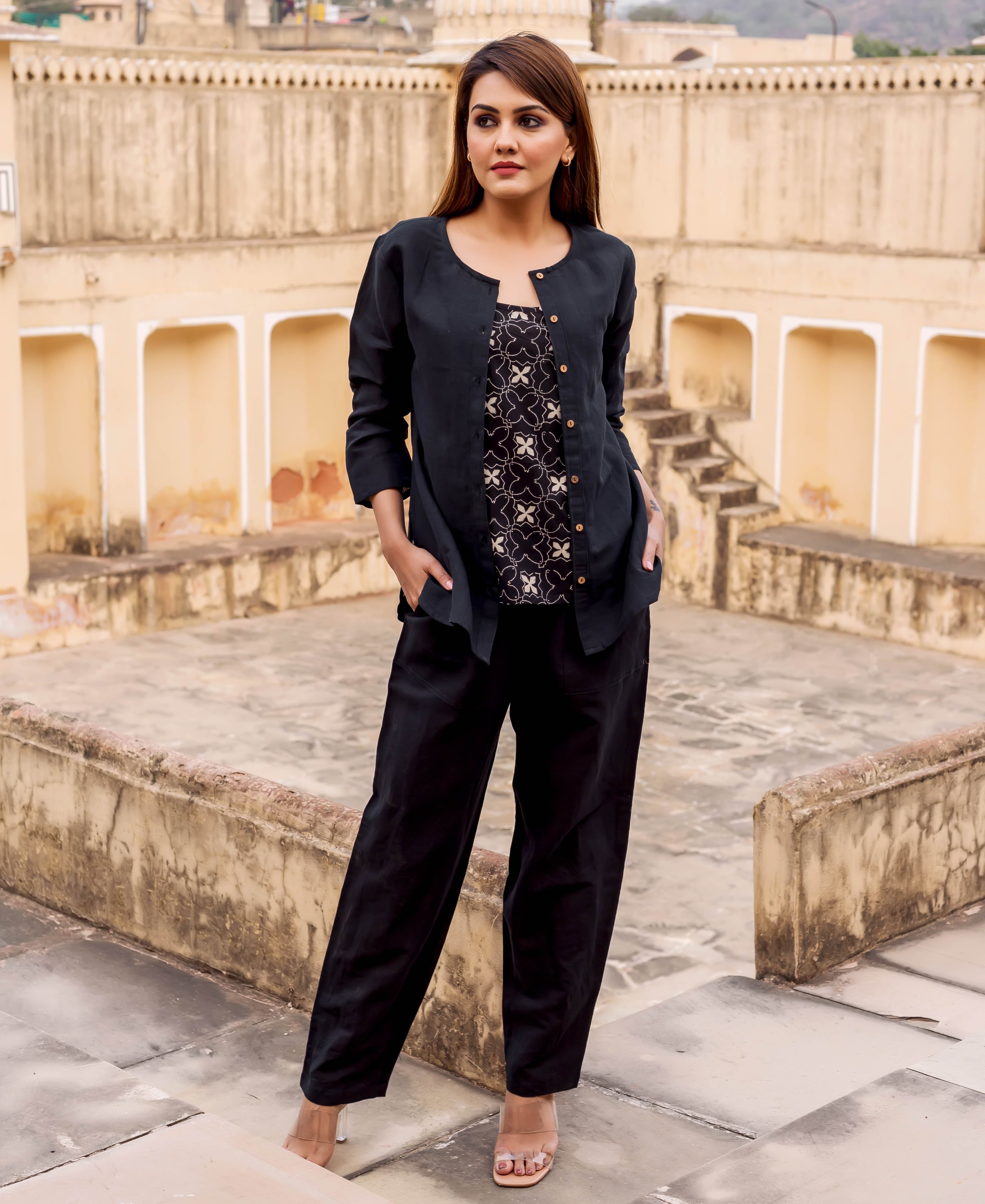 A woman models a black linen power suit with a hand-block-printed ethnic pattern.