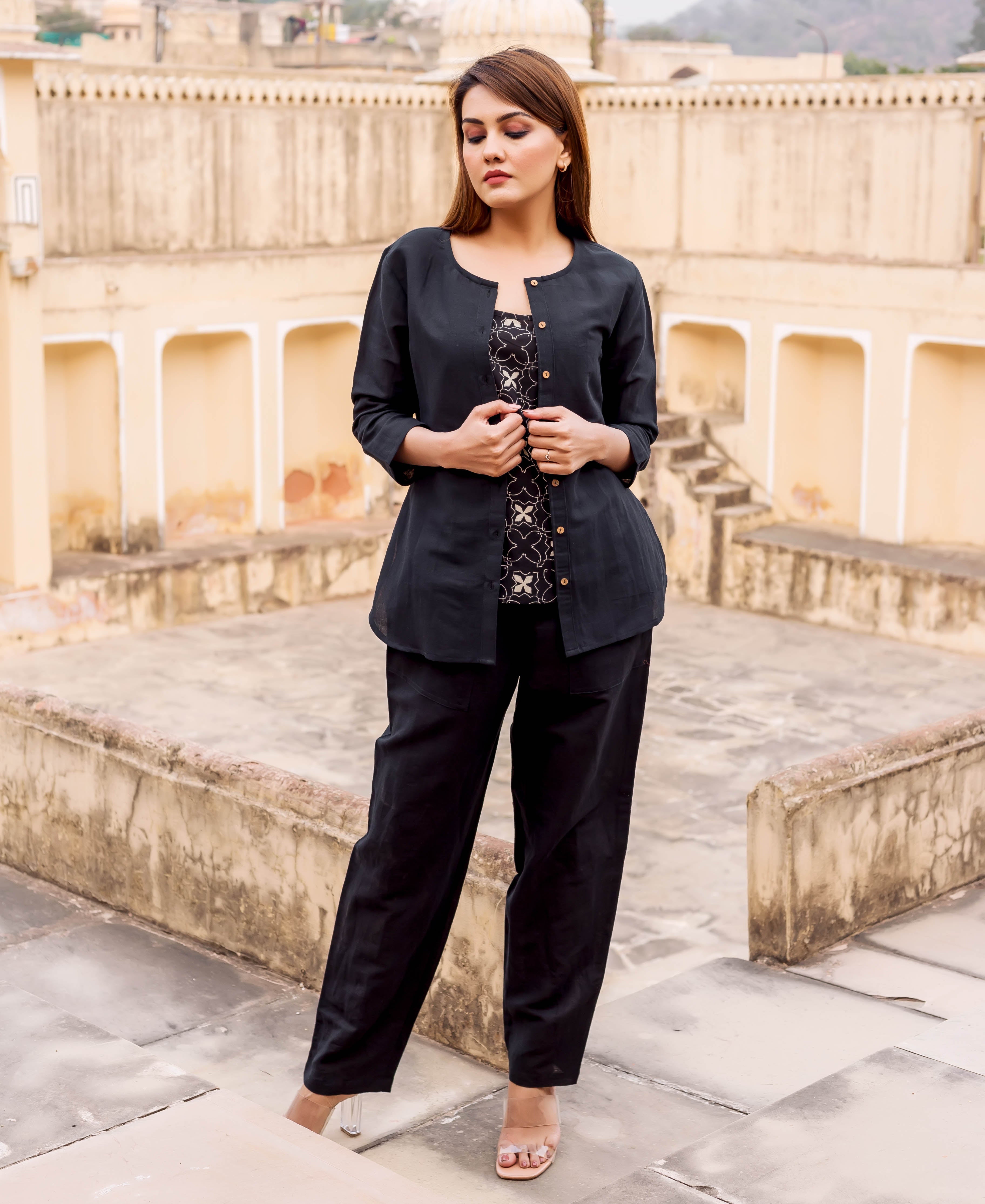 Front full look of model in black linen power suit with ethnic block-printed top.