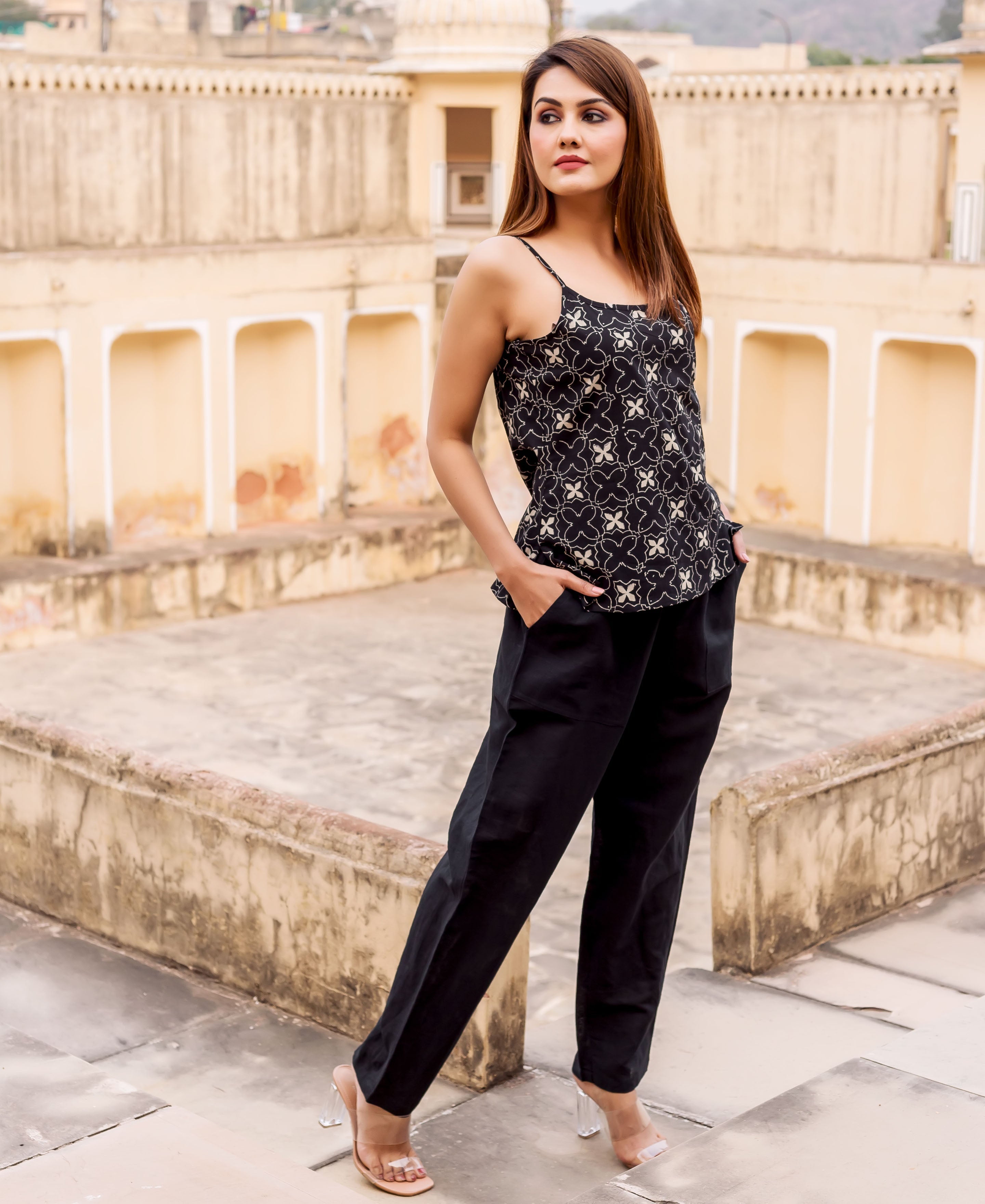 Model wearing a black camisole with an off-white block print and black relaxed-fit pants.