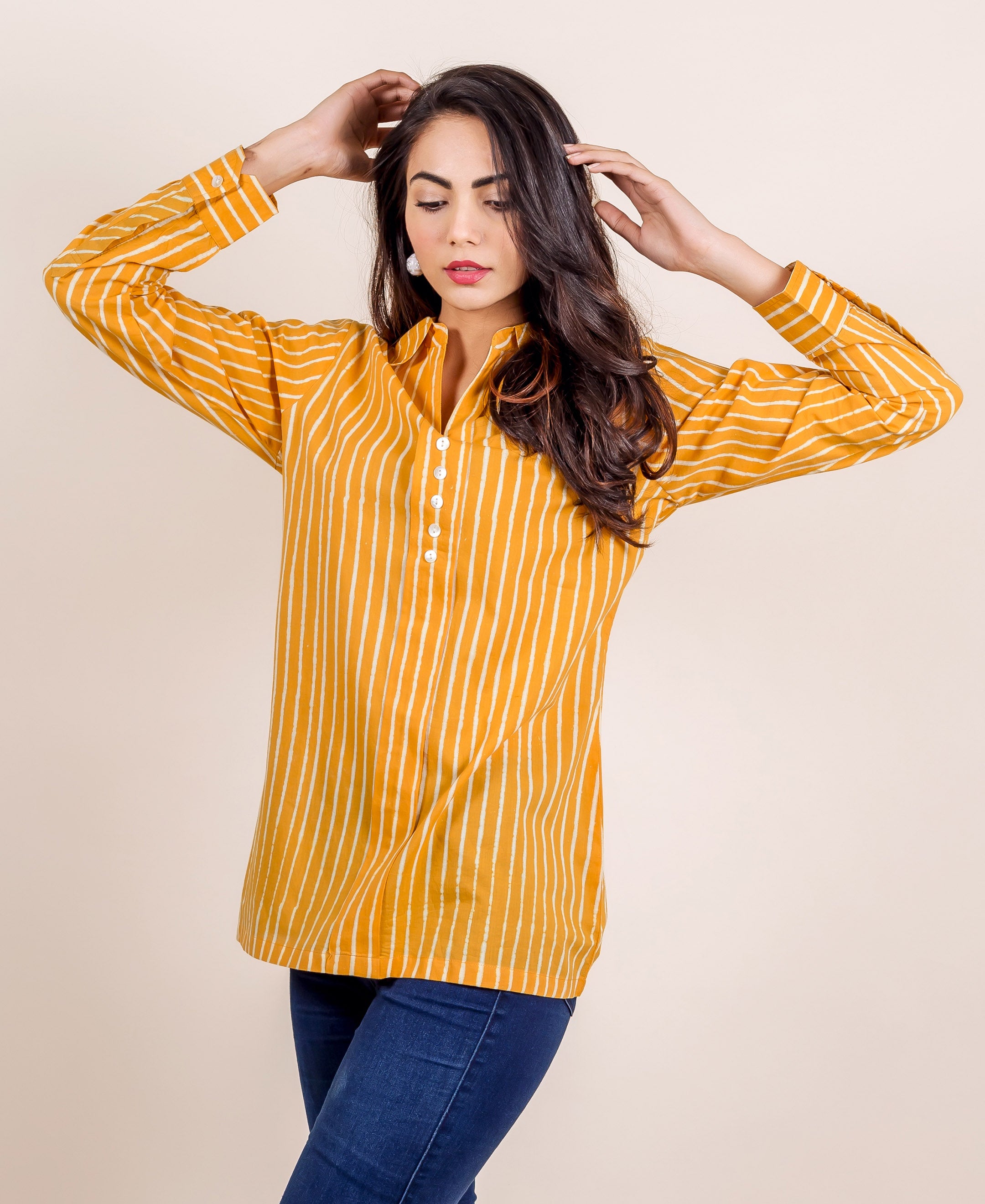 Woman wearing a yellow striped hand block printed shirt top.