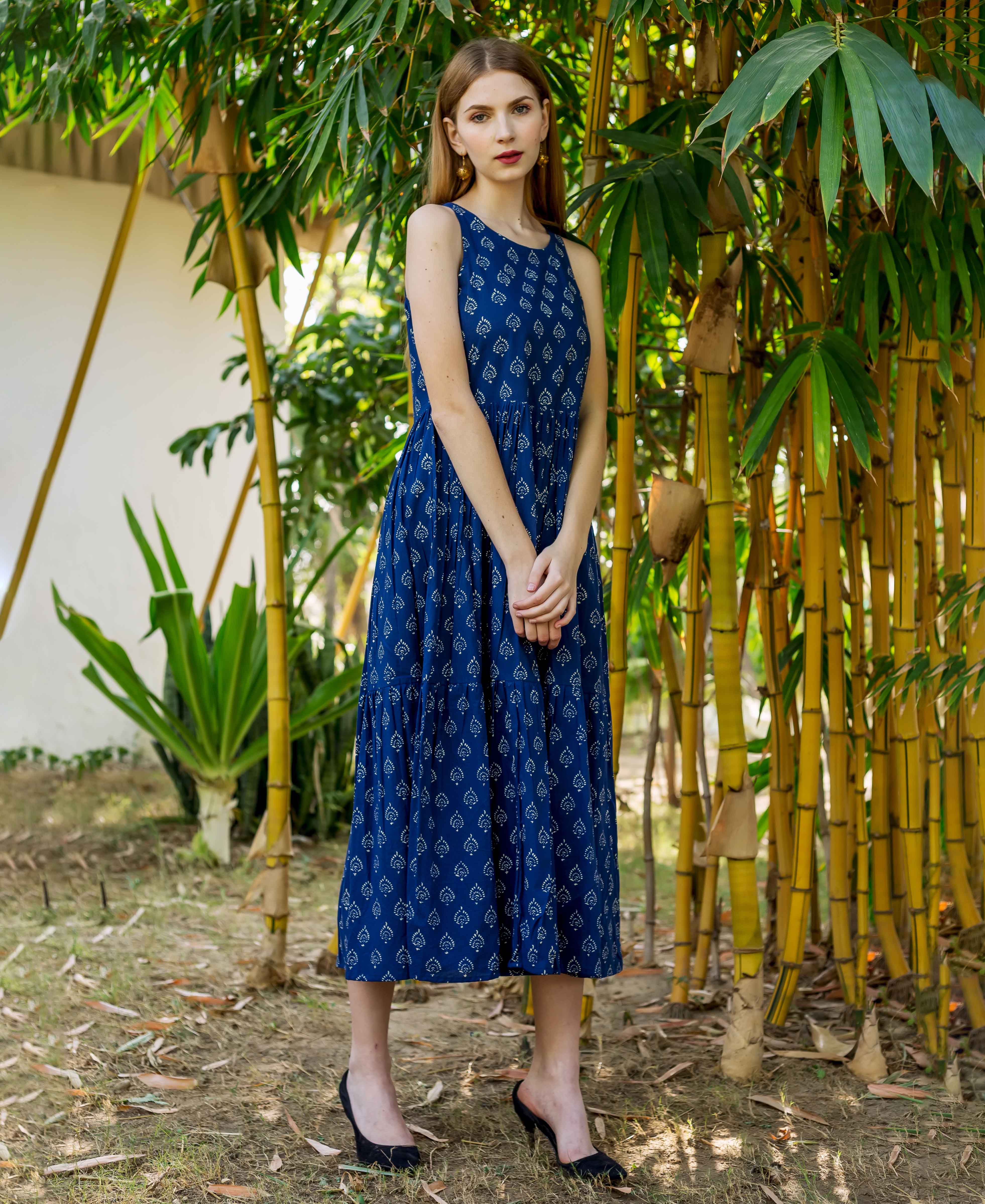 Front full look of model wearing indigo hand block printed sleeveless tiered dress.