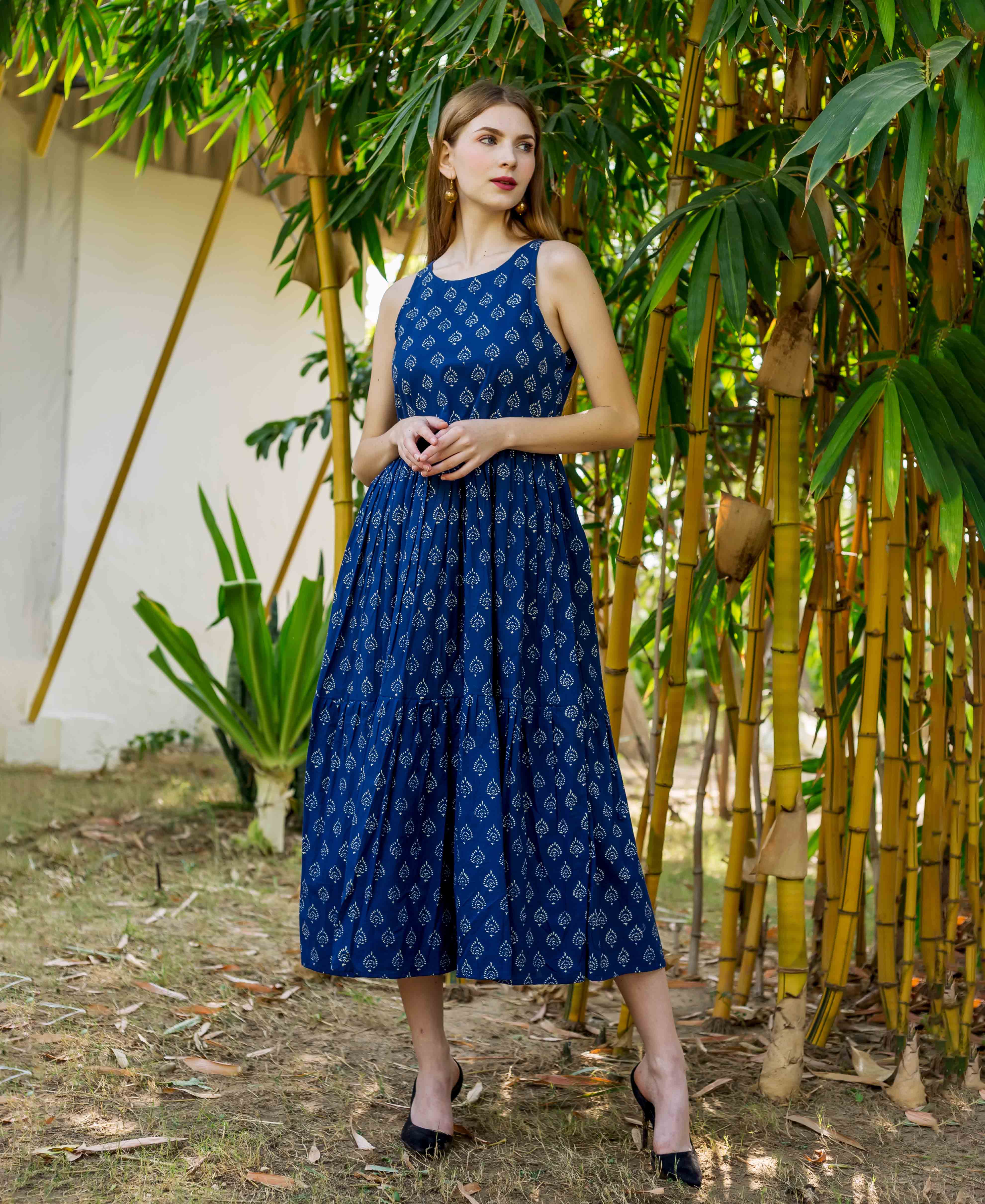Front view of model in indigo hand block printed sleeveless tiered dress.