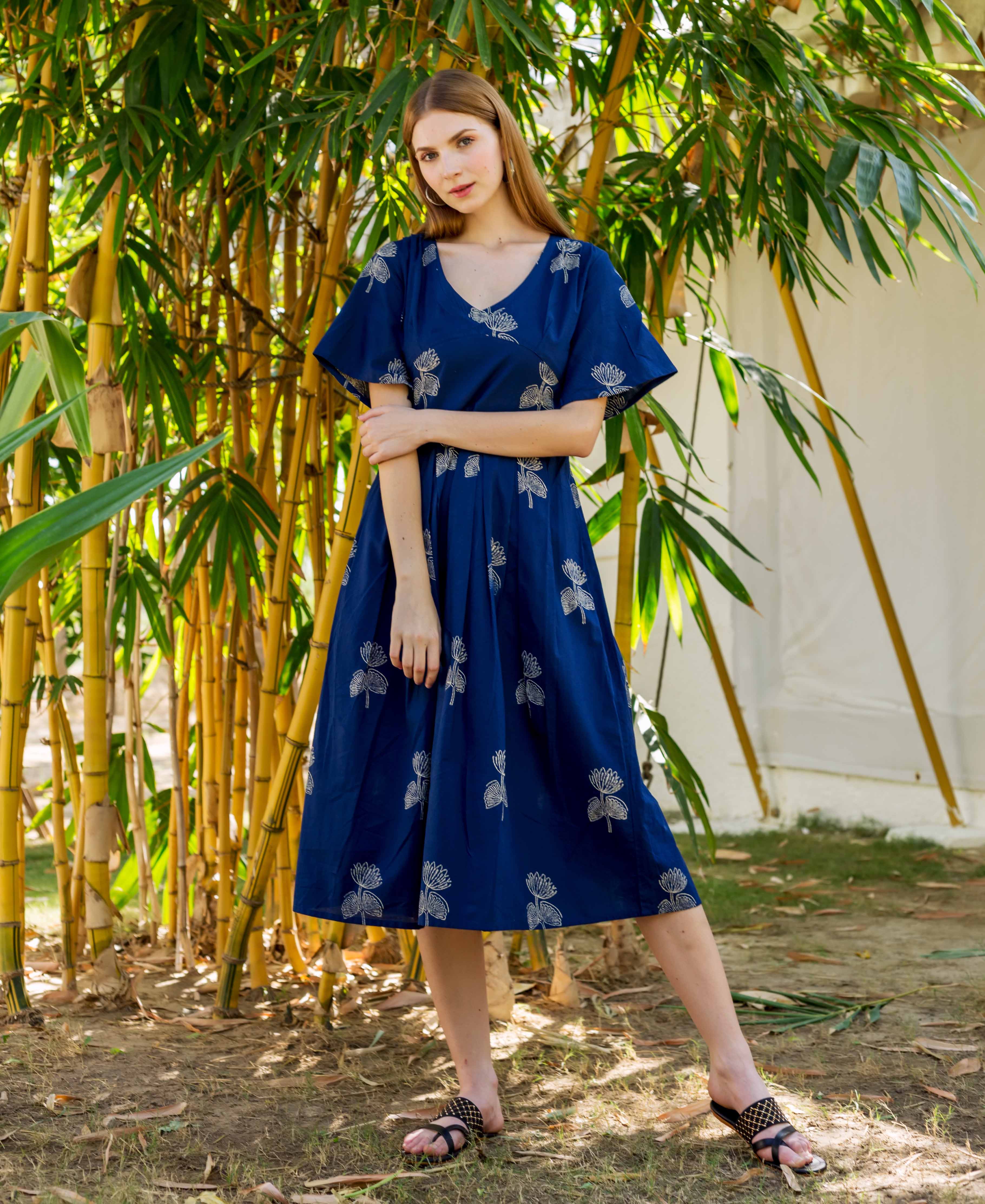 Front-facing model wearing a full-look indigo blue dress with white floral hand-block print.