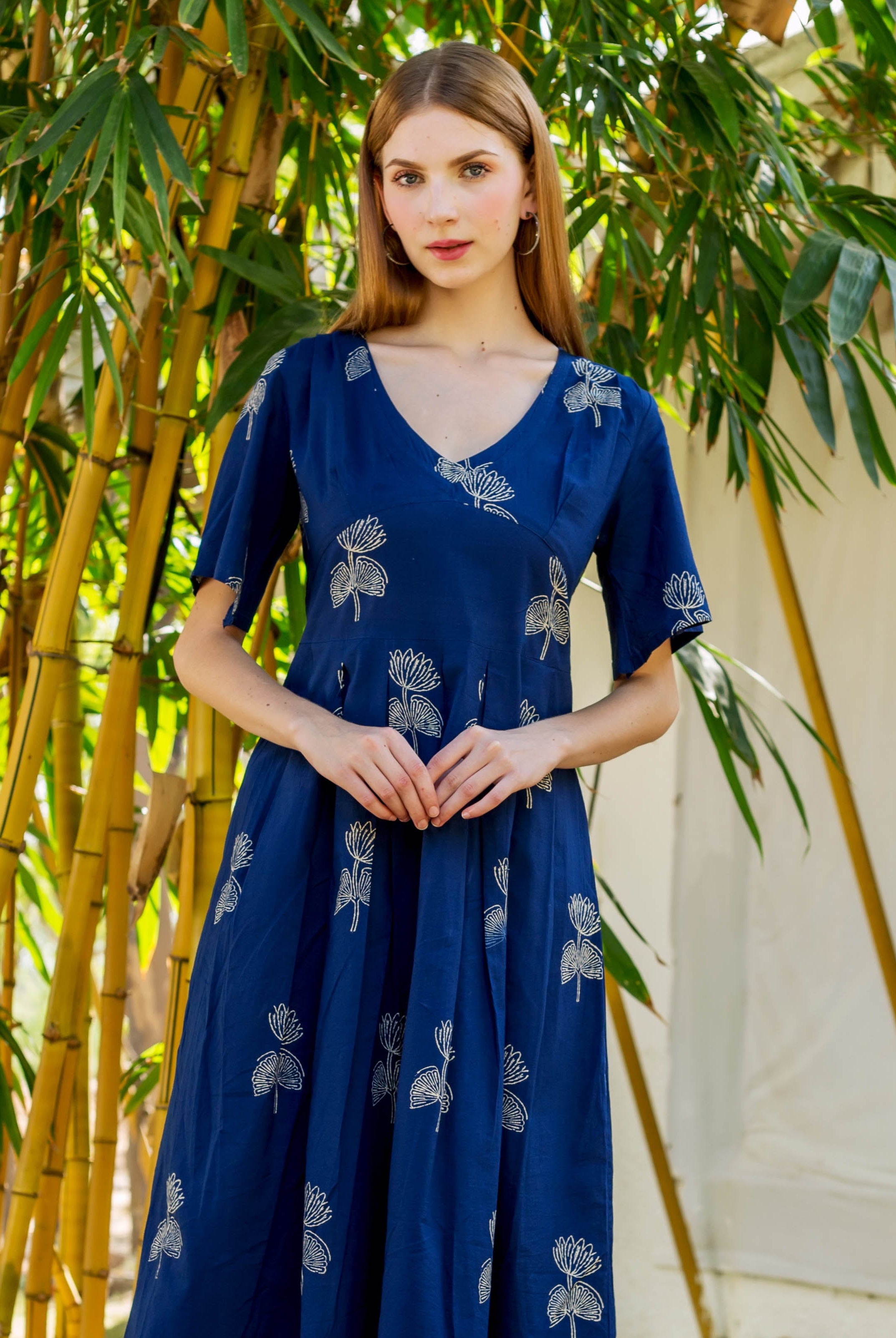 Front view of indigo Ayesha dress, hand-block-printed with white floral motifs, on model.